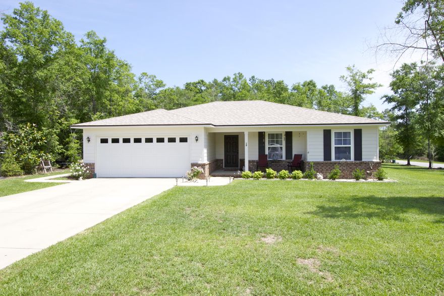 Like brand new with loads of extras on a corner lot on Hunters Ridge. Custom floor plan only built once! Very open with really spacious & comfortable room sizes throughout. Kitchen with gorgeous espresso cabinets, eating area & even has room if you'd like to add an island. Easy care vinyl-wood floors throughout except the bedrooms. Master bed w/ french doors to the master bath with raised vanities, walk-in closet and separate water closet. Bedroom #2 has an extreme walk-in closet...on it's own, it's 8'x12'! Screened and tiled back porch & fully sodded yard. Attic foam insulation installed keeps your electric bills ultra low and your home totally comfortable. Brick and cement fiber siding add value and keep it low maintenance. Meticulous maintenance is evident. Come see your new home today!