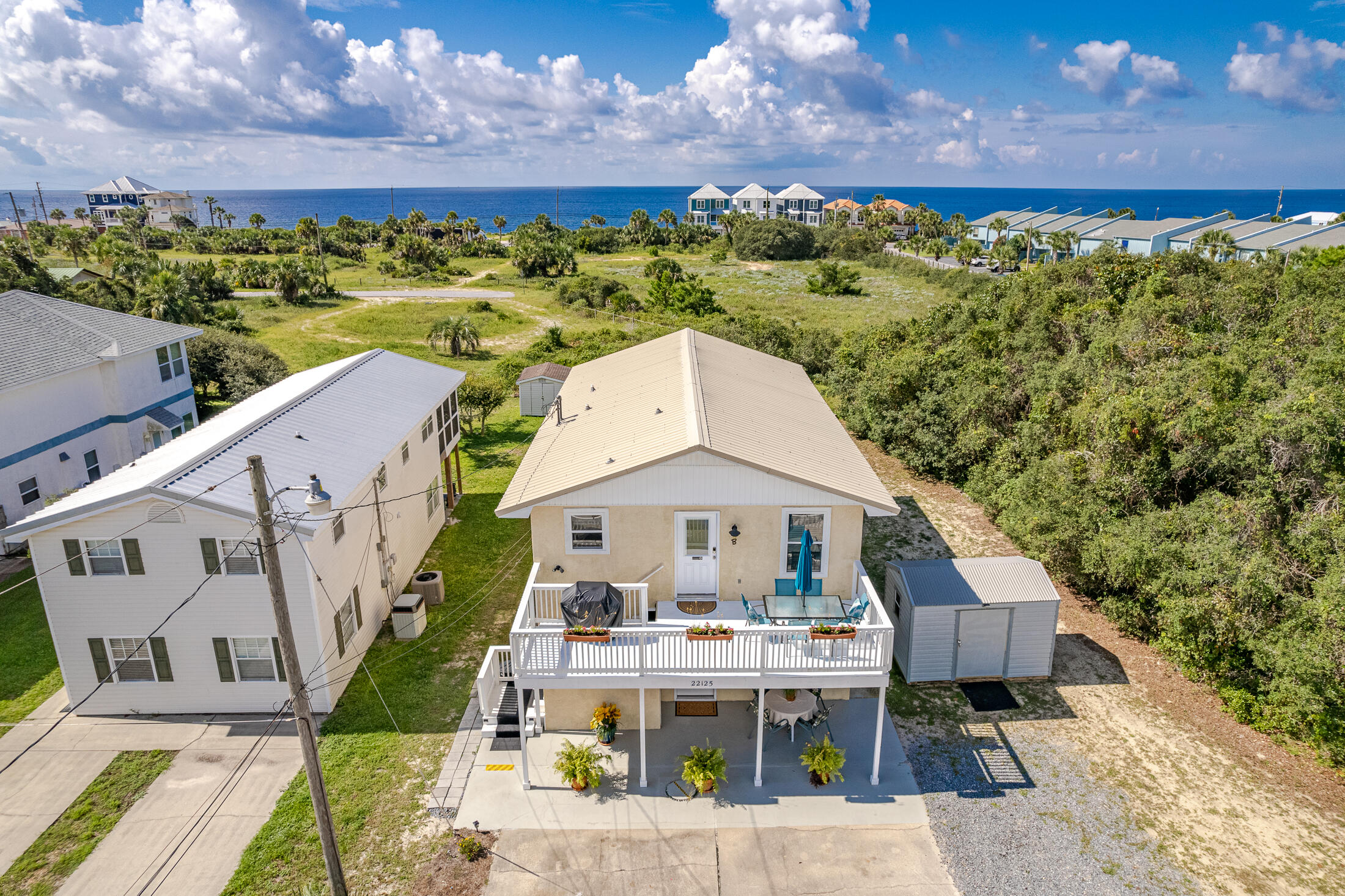 This incredible investment opportunity includes both units of a duplex located only 2 blocks to the beach. The upstairs unit even offers a view of the gulf! You'll love the nice size balcony to wind down and relax where you'll enjoy fresh sea breezes and the invigorating smell of the salty air. Both units each offer 2 bedrooms and a private living room/kitchen so it would make an excellent rental. They are beautifully decorated with a coastal vibe and ready to use. The spacious yard offers a feel of privacy and would be great with a pool. Short term rentals are allowed. Or live in one while renting the other. So many possibilities!