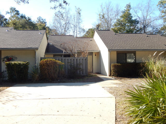 This one level townhouse is in great condition and in a wonderful location. Close to the bay and Bluewater Bay resort and golf. The home has 2 large bedrooms, tiled floors in the entire home with the exception of the bedrooms which are carpeted. There is an inviting sunroom that is fully finished and tiled. (not included in the square footage) The kitchen is roomy with a sunny breakfast nook area, tiled floors, oak cabinetry, a work center and all major appliances. The home is serviced by an efficient HVAC system that is only 4 years old. There is a high vaulted ceiling in the great room and a separate dining area. Backed up to the privacy of woods and a running stream, this would make for a great home to live in or to use as vacation rental investment. This home can be bought furnished.