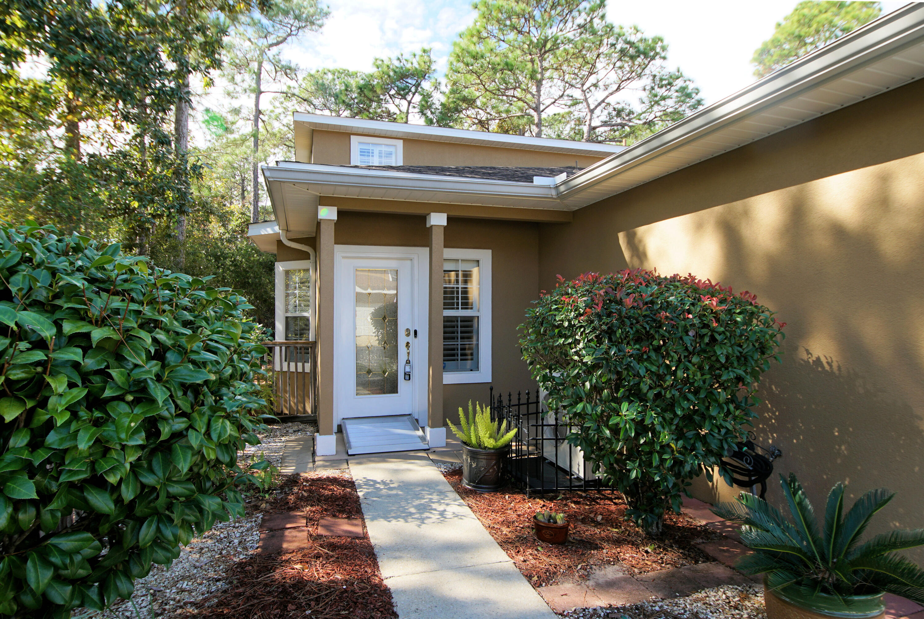Welcome to your new luxury townhome!  This end location has the most private and serene setting with woods on two sides.  Enter and you have updates and upgrades galore! New Roof in 2021, New HVAC in 2021 (18 SEER) Lots of Plantation Shutters, New and Upgraded ceiling fans, NEST system for thermostat and security cameras.  LVP over the original tile in Family room. The kitchen enjoys wood grain porcelain tile  and upgraded cabinets, deep sinks, Staron countertops,  upgraded faucet 2021, Dishwasher+ stove+ Microwave 2018, Fridge 2017. Remote shades in Breakfast area. , Sun porch and windows 2006 with porcelain tile leading out to a deck for grilling!  2 Masters! Both Master Bedrooms and loft have warm, engineered hardwood floors 2010 with new ceiling fan in 2022..Barn doors 2018 lead to Mba