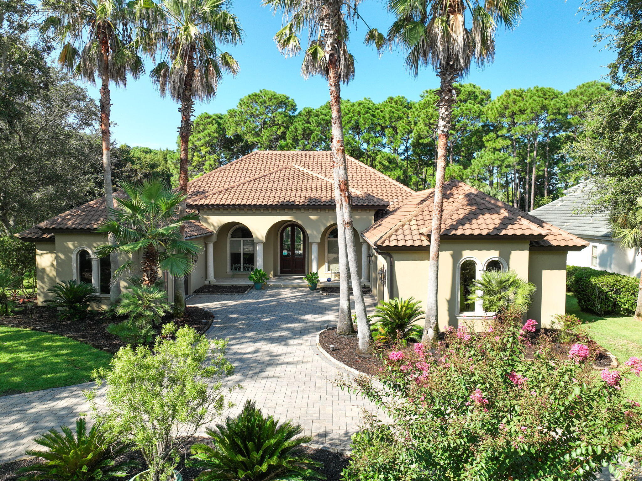 Gated resort Living at its Finest located in Regatta Bay the #4 Ranked Golf Course in Florida! Nestled on a premier homesite with lake and golf course views, this single-level estate exudes European charm. The home features two spacious living areas, a formal dining room, a cozy kitchen nook, three bedrooms, 2.5 bathrooms, and a dedicated office. Walk in to the stunning 35-foot wall of windows showing off the sparkling pool and private back yard, and seamlessly blending indoor and outdoor living. The gourmet kitchen is a chef's dream, equipped with high-end CafA(c) appliances, a Sub-Zero refrigerator, gas stove, convection oven, microwave, dishwasher, and wine cooler. The primary suite offers refined finishes, ample closet space, a wet bar/coffee station, and direct lanai access. Additional bedrooms are thoughtfully designed, complemented by two garages for three vehicles and 580 square feet of floored attic storage. A perfect fusion of luxury and functionality. Location is everything when you can take your Golf Cart to Dinner, Shopping, Marina, School and Beaches within just minutes from your home! Regatta Bay is one of the few Resorts that offers a Red light to exit or cross over Highway 98. Golf Academy & Member's covered practice area with greenside bunkers, Pool and Playground, Tennis & Pickle Ball Courts, Member's Lounge, Library, and Locker Rooms, Trackman Technology from PGA Professionals, GPS System on all golf carts, Discounts at the Pro-Shop and Restaurant, Private Golf Bag Storage, On-course circulating beverage carts, Lulu's Restaurant & Bar on The Bay, Access to the private pool & bar overlooking the Choctawhatchee Bay, Boat Storage Options, Marina Ship Store, Boating classes.