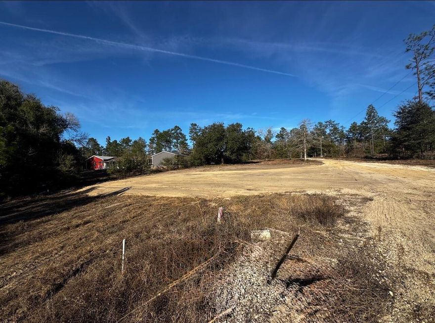 Discover this 12.19-acre lot located at the north end of Crestview. The property is partially cleared and features a ready-to-use landing pad, making it perfect for an RV hookup, tiny home, mobile home, or your dream home. Utilities are already in place, including a deep water well, septic system, and power pole. The wooded areas combined with a natural spring-fed creek ,create an ideal setting for your future residence. Whether you're seeking a peaceful retreat or a great spot for a mini farm, this land is ready for your vision. Bring your horses, chickens, goats, and pigs to enjoy this wonderful property!  Call today to view your future home site!