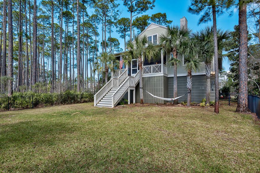Nestled amongst towering pines, this custom built residence with it's own private dock and boat lift on the Choctawhatchee bay is a tranquil escape within convenient proximity to the energy and activity of Scenic Highway 30A. Located in the sought after gated community of Cessna Landing, this 5 bedroom, 4.5 bathroom home enjoys an open floor plan, ideal for entertaining. Replete with delightful designer touches seen in the chef's kitchen with top-of-the-line appliances, granite countertops, dual dishwashers, warming drawer, wine cooler and ample bar seating, all looking out over the great room and view of the bay beyond. A butler's pantry is adjacent to the kitchen. The screened porch offers an outdoor alfresco kitchen with heating lamps along the perimeter for those cooler evenings.