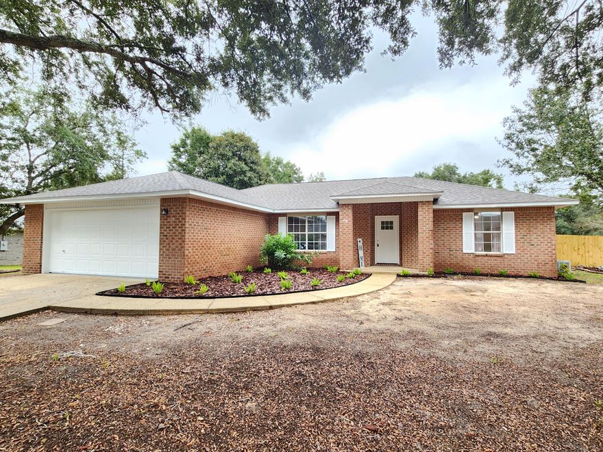 Welcome to this charming 3-bedroom, 2-bathroom home located in the vibrant city of Navarre, FL. This property boasts a modern design with vinyl plank flooring throughout, adding a touch of elegance to the space. The kitchen is equipped with top-of-the-line stainless steel appliances, ready to inspire your inner chef. The home also features convenient washer/dryer hook-ups, ensuring laundry days are a breeze. The exterior of the house is just as impressive with its durable brick siding and a spacious 2-car garage. One of the greatest advantages of this home is its prime location. It's situated close to a variety of shopping destinations and dining options, offering a lifestyle of convenience and enjoyment. This home is a perfect blend of style, comfort, and location.