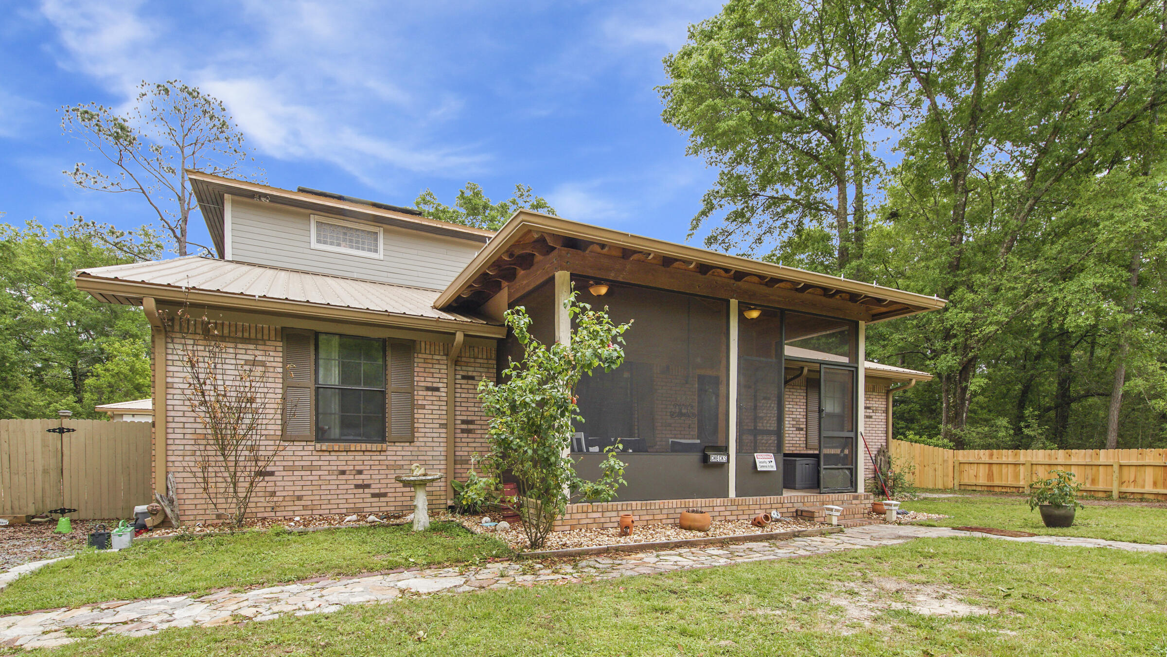 There is much more than meets the eye with this spacious, one of a kind custom home. The 2300SF addition was added by the former owner, a building contractor, with no detail or extra spared. This layout of this two story home would be great for blended or multigenerational families. It has a total of 5 bedrooms plus 2 addtl home offices that could easily be converted for a total of 7 bdrms! The beautiful kitchen and great room ceilings soar, making it feel even more grand. This kitchen has it all, including a huge pantry, abundant cabinets/granite countertops, and details like arches and a trey ceiling. Tile, laminate and cool epoxy floors (no carpet) make it easy to maintain. You'll find the original house downstairs with a split plan and downstairs master suite and 2 additional