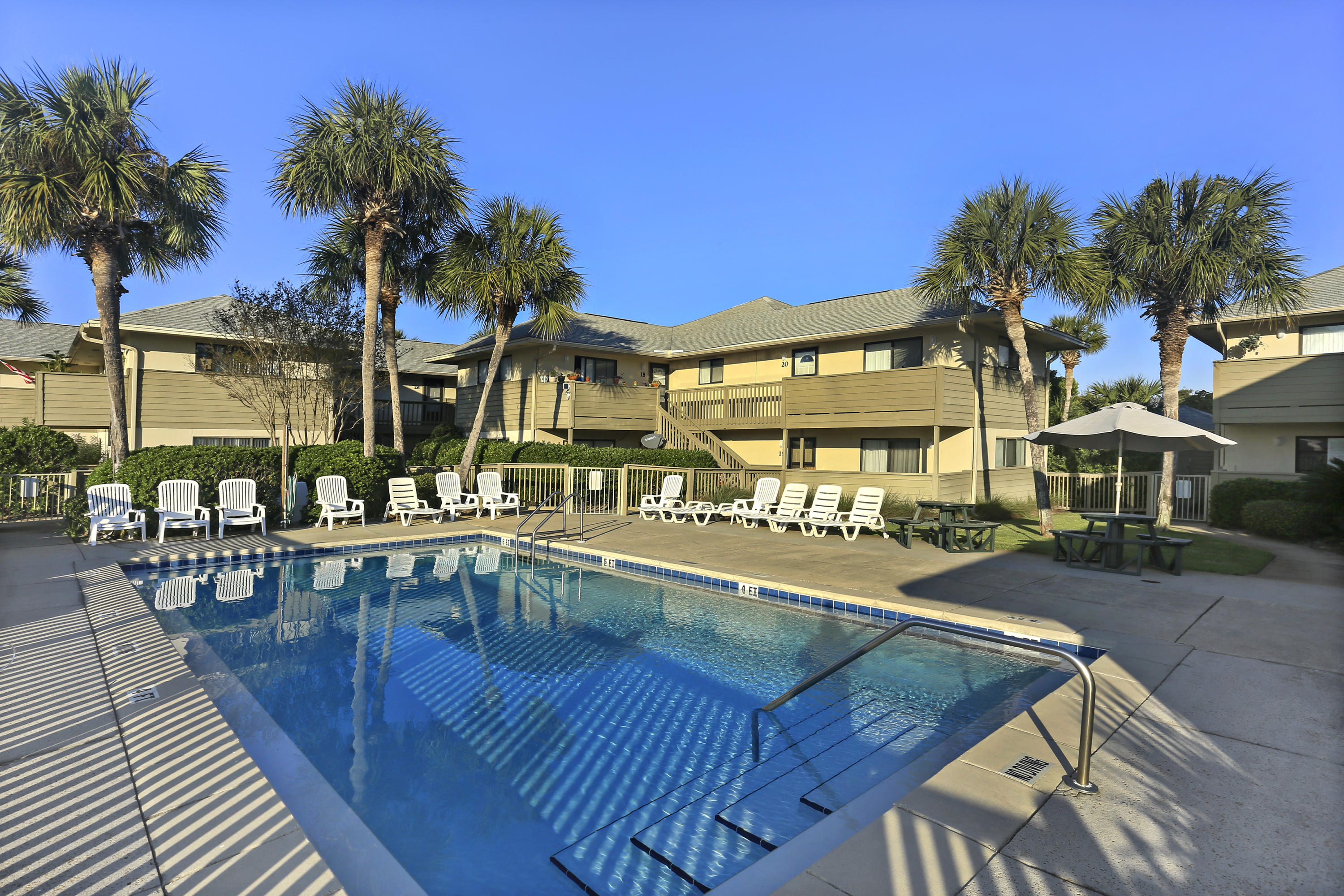 Idyllic beach getaway just one block from the Gulf. Spacious condominium with cottage furnishing ready to host the family and friends. After a beautiful day in the emerald green waters, relax at the pool. Call this place home or this condominium easily serves as a profitable opportunity as a VRBO or as a long term rental.