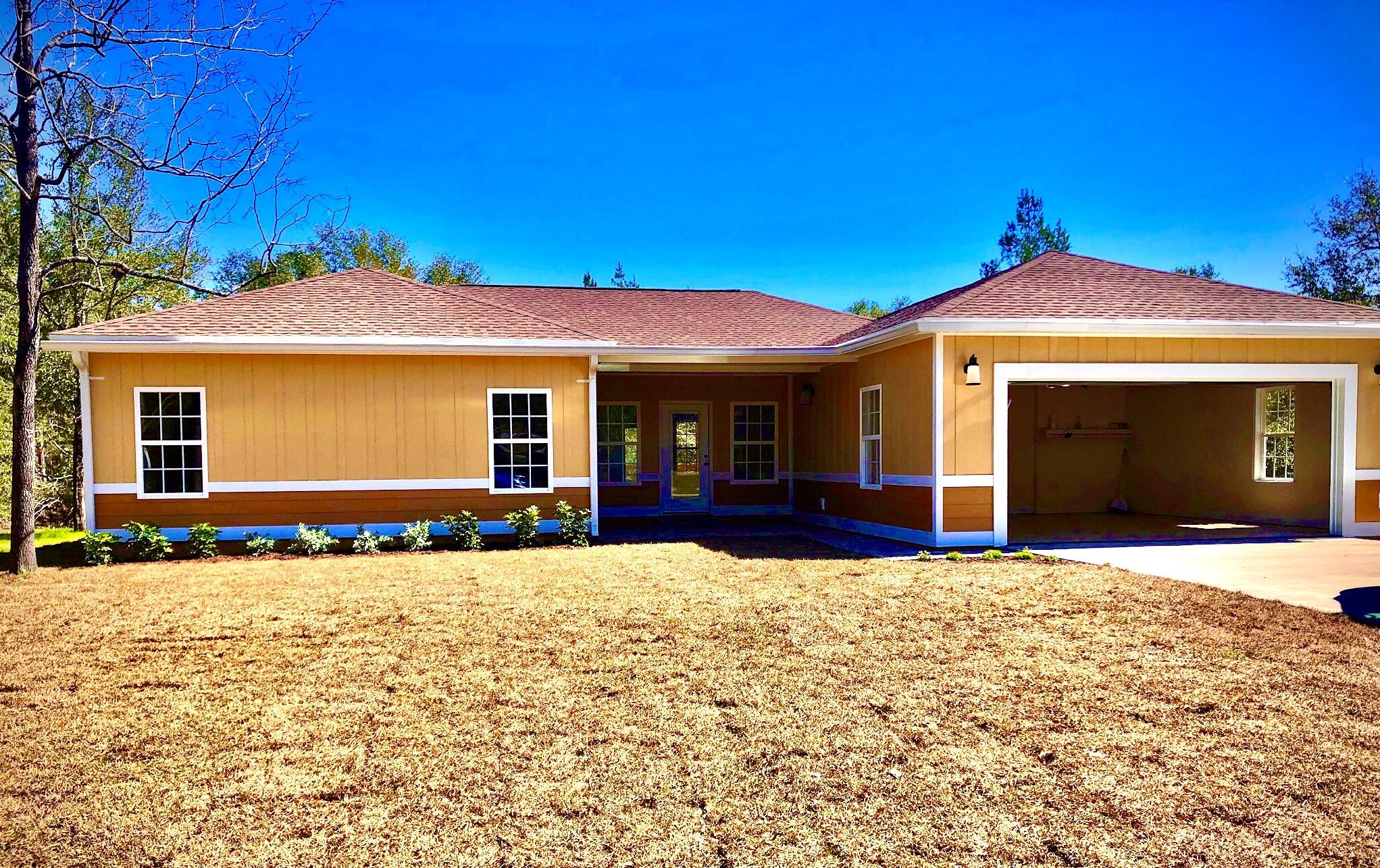 NEW HOME sitting on 1.2 acres,landscaped, half of it cleared remainder wooded, 4 bedroom 2 1/2 bath, garage and covered porches in a good neighborhood ,all the bells a whistles,including foam insulation on demand water heater, led lighting custom cabinetry ,granite countertops, and so much more.