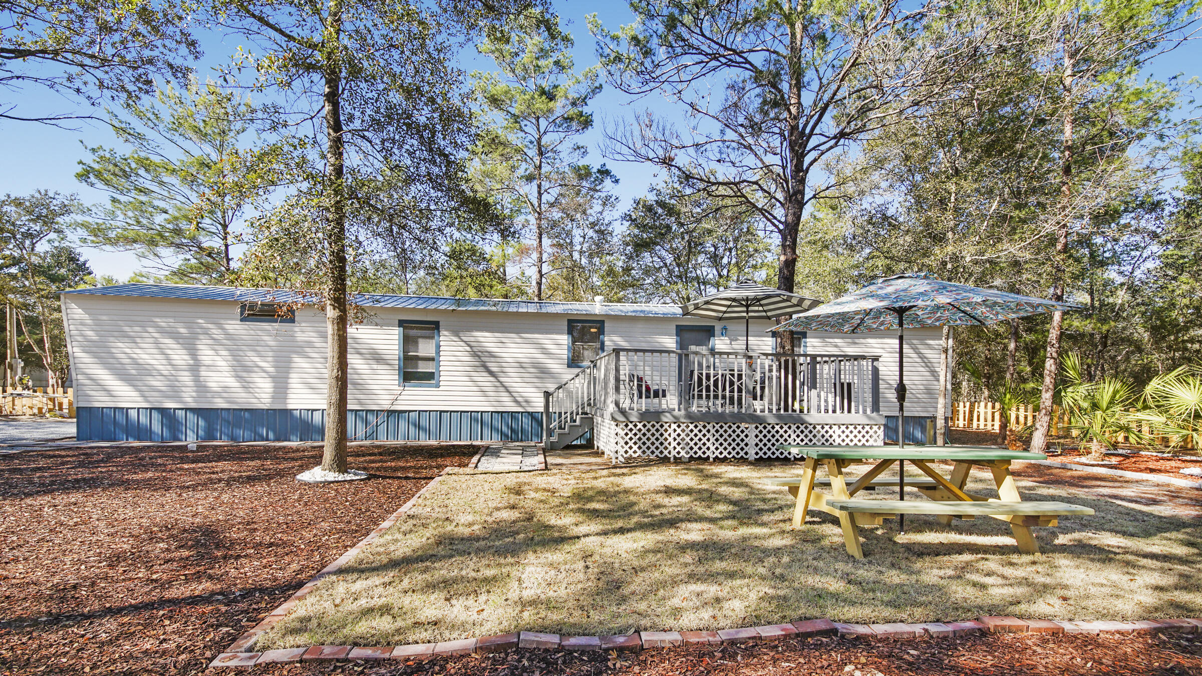 Move right in! This 2bdrm/2ba home comes completely furnished. The lot was purchased in October and the home was relocated to the property in November. The seller has made  many updates to include flooring, appliances, bathroom tile, and vanities. The home also has a  new metal roof, skirting, septic system and AC unit. You'll love spending time on the newly constructed patio deck with included outdoor furniture and grill. The yard has all new landscaping: palms, sod, mulch and a wooden fence. The home is connected to Mossy Head Water. Great location, close proximity to I-10, Crestview, DeFuniak Springs and two Dollar Generals. If you are looking for an investment property or turn key home here it is! Seller only accepting cash offers.