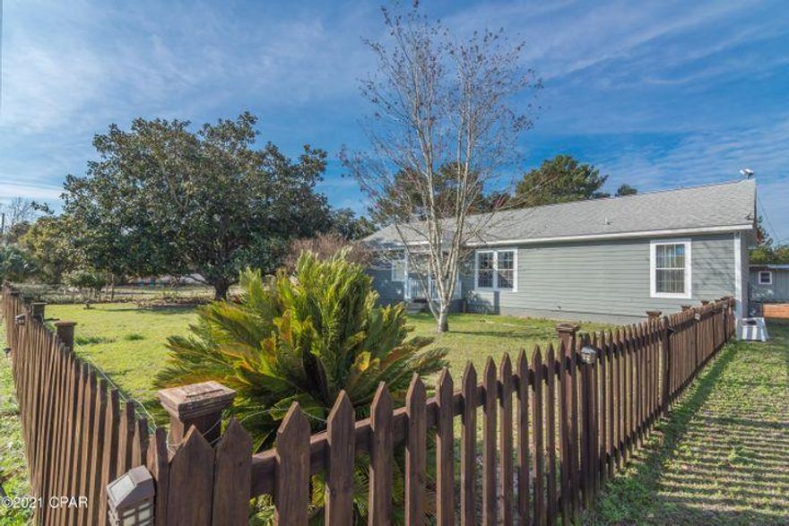 Just bring your clothes! Rare find on the coveted West end of Panama City Beach. This 1,931 square-foot home boasts a HUGE (double) half-acre lot with beautifully established trees and privacy. Adorably maintained and FURNISHED, this home is move-in ready with a spacious three-bedroom, two-bath. Your new home is conveniently located within 1/2 mile of the white sandy beaches of Sunnyside and a short three-minute drive to Rosemary Beach. This home is within walking distance of shopping, medical care, restaurants, and Lake Powell Park. This home boasts an open and spacious floor-plan, 10-foot ceilings with 18-inch ceramic tile flooring throughout the home, and bathrooms with carpet in all bedrooms and crown molding throughout the house.