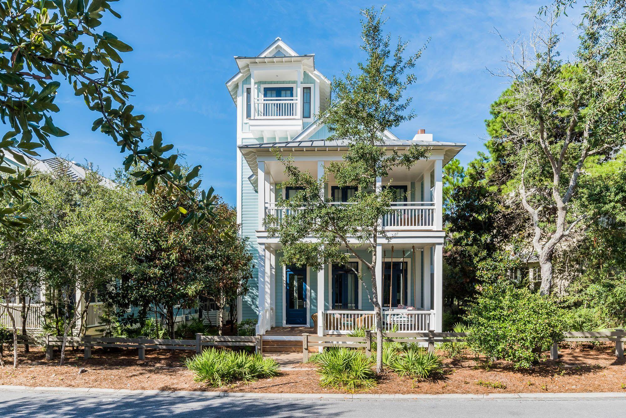 Sweeping front porches, cozy outdoor furniture and the perfect hues of blue welcome you to this spacious 4 bedroom, 4 1/2 bath beach house with a third floor tower. Conveniently located on Western Lake Drive in the Park District of WaterColor, this home's soaring ceilings and natural light greet you as you enter this home boasting coveted first and second floor master bedrooms. Vast windows and 12 foot ceilings accentuate an open, airy floor plan, made for entertaining guests. The expansive living room offers Southern charm with white wood paneled walls, transom windows and a brick fireplace that set the mood for making memories here. The kitchen offers high-end appliances with additional eat-in dining space and a conveniently located wet bar.