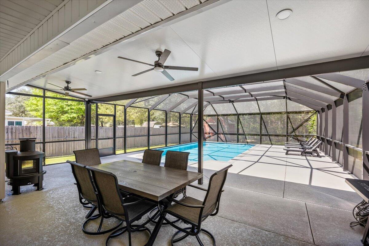 Step into this inviting 3-bedroom, 2-bathroom home, where comfort & charm blend effortlessly. The fenced backyard is a private retreat with a sparkling inground screened-in pool & patio--perfect for summer gatherings or peaceful mornings. Inside, the open floor plan flows beautifully, featuring a spacious great room with soaring ceilings, a lighted fan, & elegant plant ledge. The kitchen is a chef's dream with generous counter space, a large pantry, & a cozy breakfast nook filled with natural light & backyard views. The primary suite offers a sitting area, trey ceiling, patio access, & a spa-like bath with a garden tub, double vanity, & walk-in closet. Easy access to shopping and Whiting Field. See the full list of upgrades and make it yours!