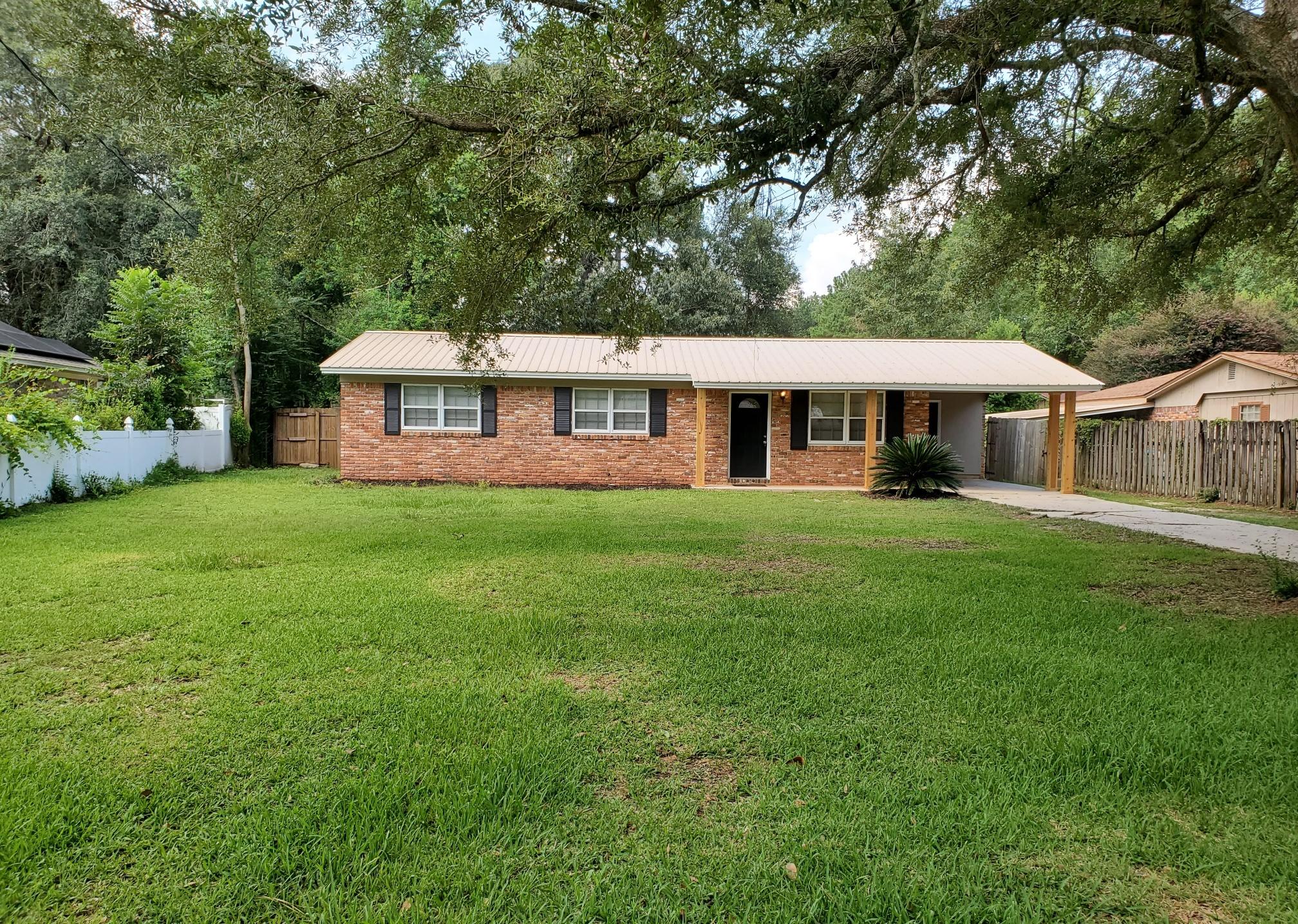 Grear 3 bedroom 2 bath rancher style home for sale in Crestview. INGROUND POOL! Metal roof. Large fenced in back yard with storage shed. Spacious front yard with shady oak tree. One car carport. Open living/dining combo and roomy kitchen. This property has been recently updated with tile flooring throughout, backsplash, updated pool liner, and fresh paint. This would make the perfect family home! Vacant and easy to show.