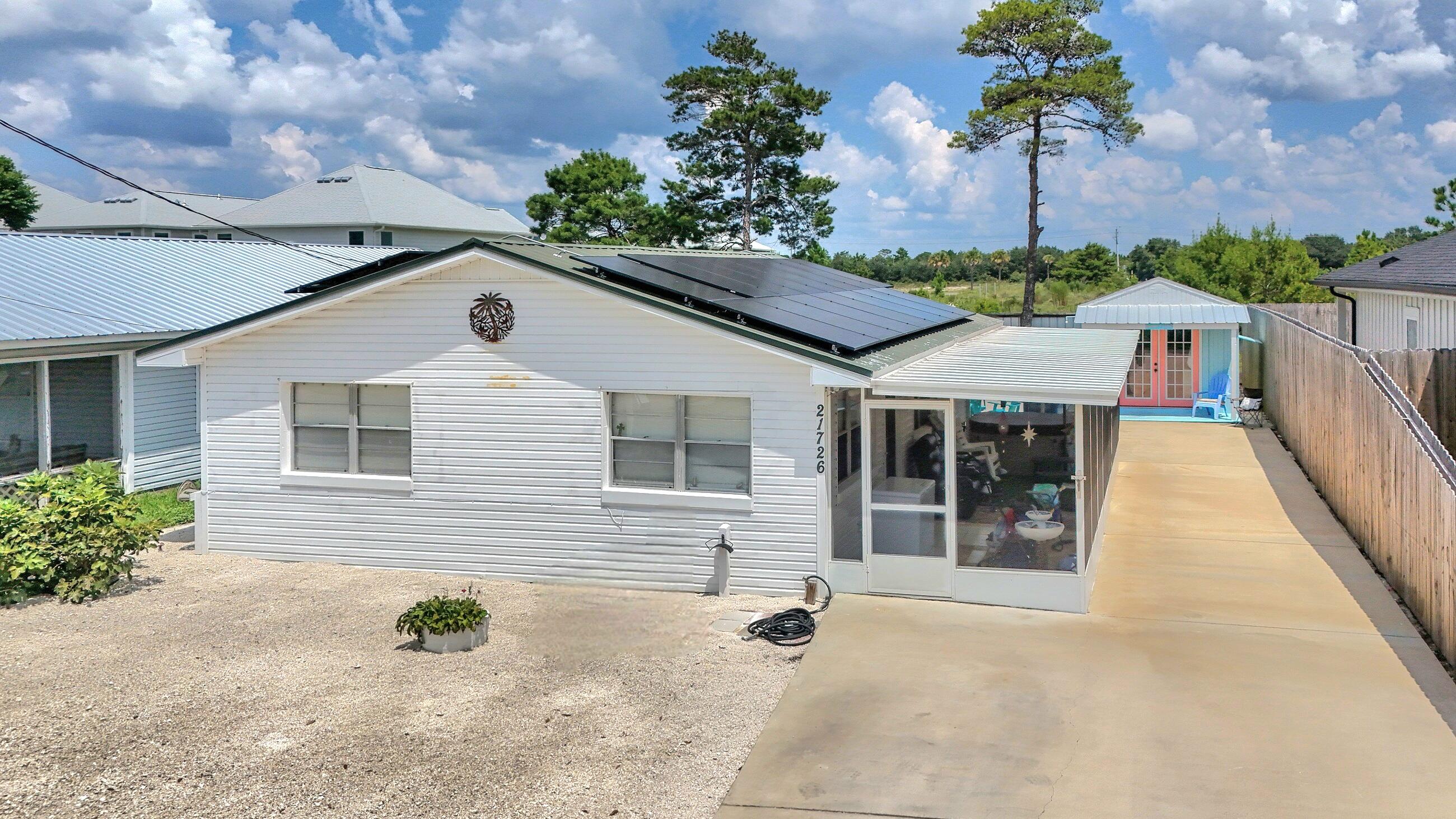 Charming Beach Cottage + Income-Producing ADU - Less than 1/2 Mile to the Beach! Located on the desirable West End of Panama City Beach, this unique property offers versatility, charm, and income potential--just a short walk or golf cart ride to the Gulf! The main home (780 sf) features 2 bedrooms and 1 full bath, full of beach cottage character and equipped with a newer HVAC. Out back, a separate studio (308 sf), 1 bath ADU with kitchenette and private entrance is currently a successful income-producing rental--perfect for guests, tenants, or extra space! Enjoy a spacious backyard ready for entertaining, complete with fruit trees, a large new shed, and a smaller shed with washer/dryer and a chicken coop! Live in one and rent the other, rent both, or keep both for yourself--the OPTIONS are endless. With its unbeatable location, dual living spaces, and strong rental potential, this is a rare find on the West End!