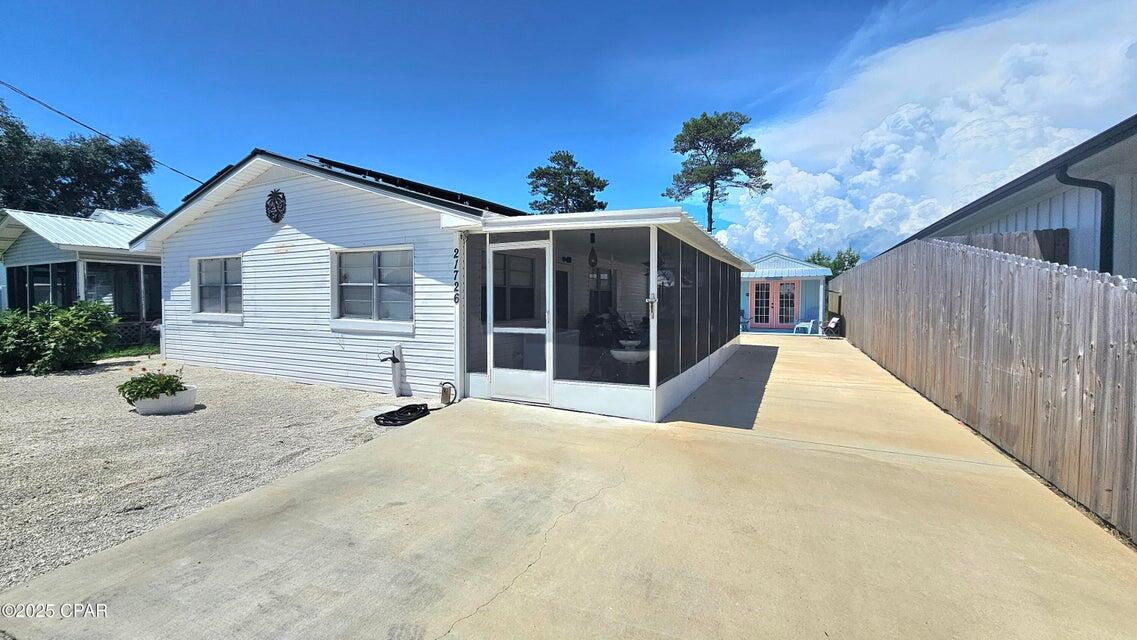 Charming Beach Cottage + Income-Producing ADU - Less than 1/2 Mile to the Beach! Located on the desirable West End of Panama City Beach, this unique property offers versatility, charm, and income potential--just a short walk or golf cart ride to the Gulf! The main home (780 sf) features 2 bedrooms and 1 full bath, full of beach cottage character and equipped with a newer HVAC. Out back, a separate studio (308 sf), 1 bath ADU with kitchenette and private entrance is currently a successful income-producing rental--perfect for guests, tenants, or extra space! Enjoy a spacious backyard ready for entertaining, complete with fruit trees, a large new shed, and a smaller shed with washer/dryer and a chicken coop! Live in one and rent the other, rent both, or keep both for yourself--the OPTIONS are endless. With its unbeatable location, dual living spaces, and strong rental potential, this is a rare find on the West End!