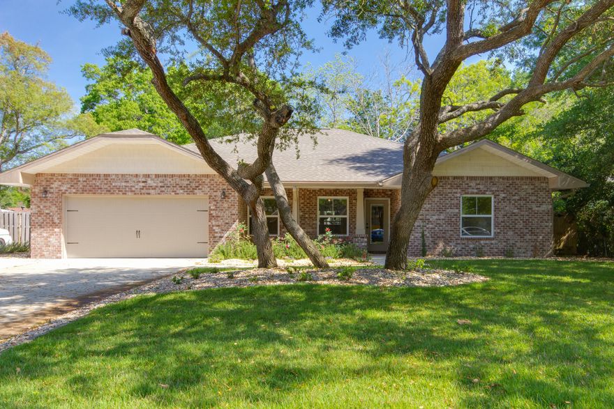 Come see this absolutely stunning home in Fort Walton Beach! This 4 bedroom, 2 bathroom home features hardwood flooring throughout all living areas, large tile in all wet areas, and carpet in all bedrooms. The formal dining room as space for a large table for gatherings, and the huge kitchen overlooking the living area is an entertainer's dream! Large windows overlook a landscaped backyard and the seller has added a large deck and raised garden beds. The split floorplan features a spacious master bedroom, and the master bathroom has two separate vanities, a walk-in closet, garden tub, and separate shower. You will be wowed the minute you walk through the door. Don't let this one get away!