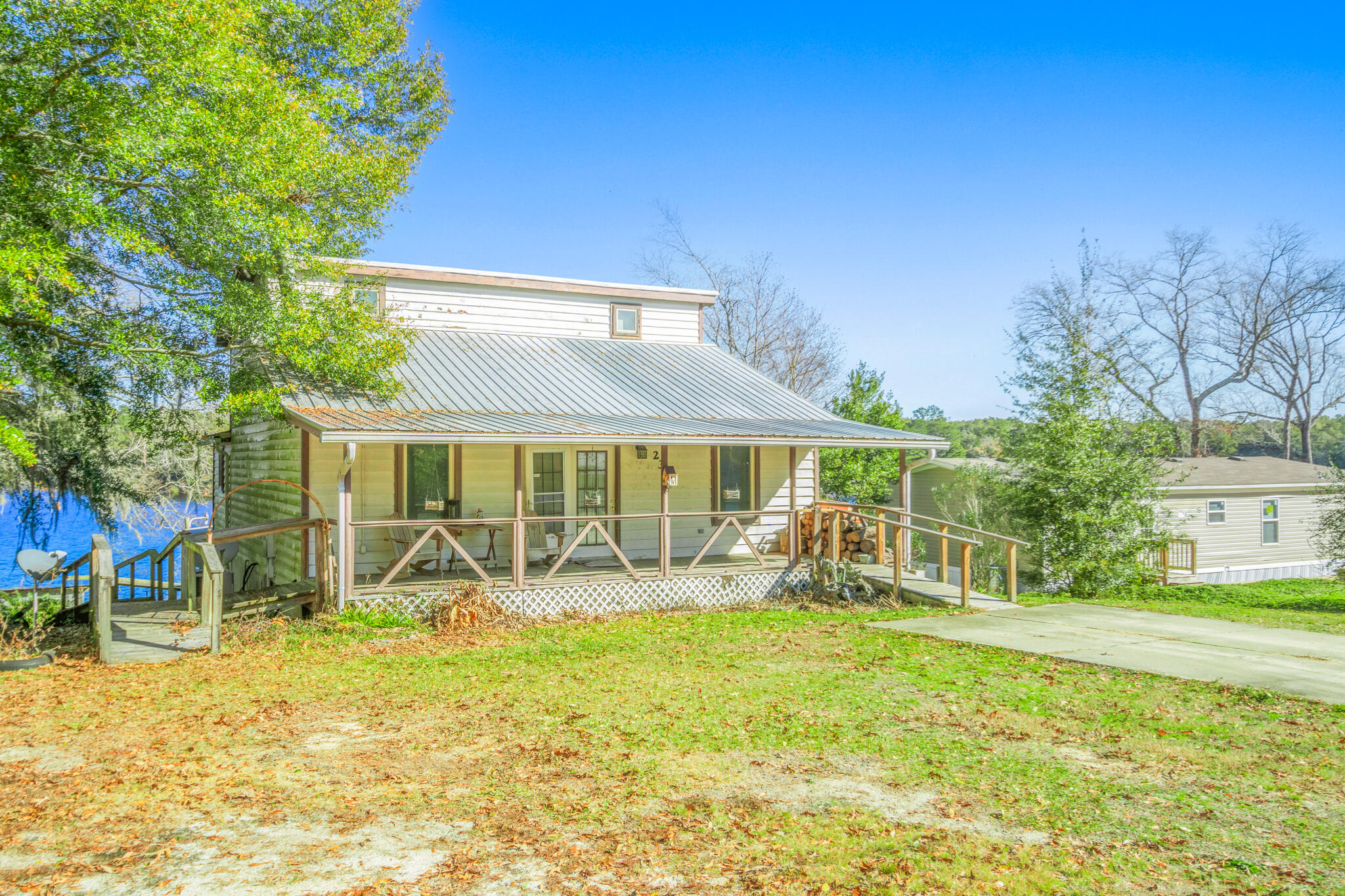 Ever dreamed of owning a slice of paradise? This waterfront gem on Lake Juniper is ready to make all your lakeside fantasies come true (with a little elbow grease, of course). With an in-ground Gunite pool that's perfect for cannonballs and lounging, and a dock with 1/2 interest in a boathouse for all your boating adventures, you're set for endless fun. Featuring not one, but TWO Master suites (who wants to share?), charming cypress plank interior walls for that rustic vibe, a custom stone fireplace to cozy up to, and an island kitchen stove that's begging for a culinary masterpiece.Lake Juniper is a state-managed lake, so you'll always have a well-kept environment, and it's famous for record bass and bream fishing--anglers, rejoice! Thinking about turning this beauty into an Airbnb? It's the perfect getaway spot that may have guests booking faster than you can say "lakeside retreat." KEEP IN MIND, this home will need some work to get it into tip-top shape, but the rewards could be well worth it. Don't miss out on this exceptional property, shown by appointment only. Your dream waterfront home (and potential vacation rental goldmine) awaits!
