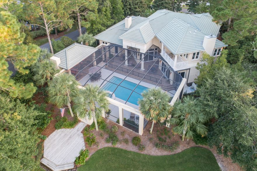 This is THE BEST BUY in Sandestin! If you are looking for a BIG home with incredible outdoor space on one of the most picturesque settings in Sandestin, you need to check out this home! The standout features include amazing view of THE Island Green on Raven Golf Course, the outdoor space is an entertainer's dream with pool, hot tub, large covered outdoor kitchen with fireplace, the floorplan has LARGE rooms and an awesome Master Bedroom downstairs with a fireplace. This is a rare chance to not only get a home with this one-of-a-kind setting, but it offers incredible space inside and out with many special details. It does need some updating but at this tempting price you can afford to do that and have a truly extraordinary estate!