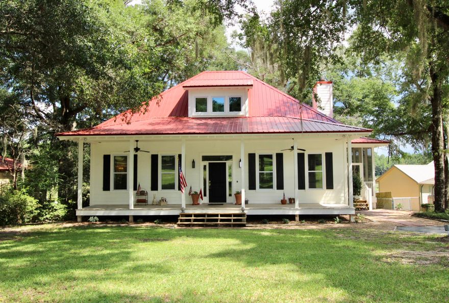 Sharp price adjustment! Charming New Orleans style custom bungalow with full 1600sf walkout basement on Lake Juniper! Fabulous open concept floor plan w/ 10' ceilings & downstairs master suite overlooking the lake. This quintessential southern kitchen evokes thoughts of mama's cookin'! Antique island with custom cabinets - lowers are all drawers for maximum functionality. And a stand out farmhouse sink with wall mount faucet! Soak up the water views with French doors from the waterfront master bed - or living room - to your wrap around porches (1 screened, 1 open). Master features his & hers walk-in closets, double vanity and 5' shower. Plumbed for a soaker tub too! Multi purpose room serves as bedroom/office/laundry on 1st floor plus a powder bath for