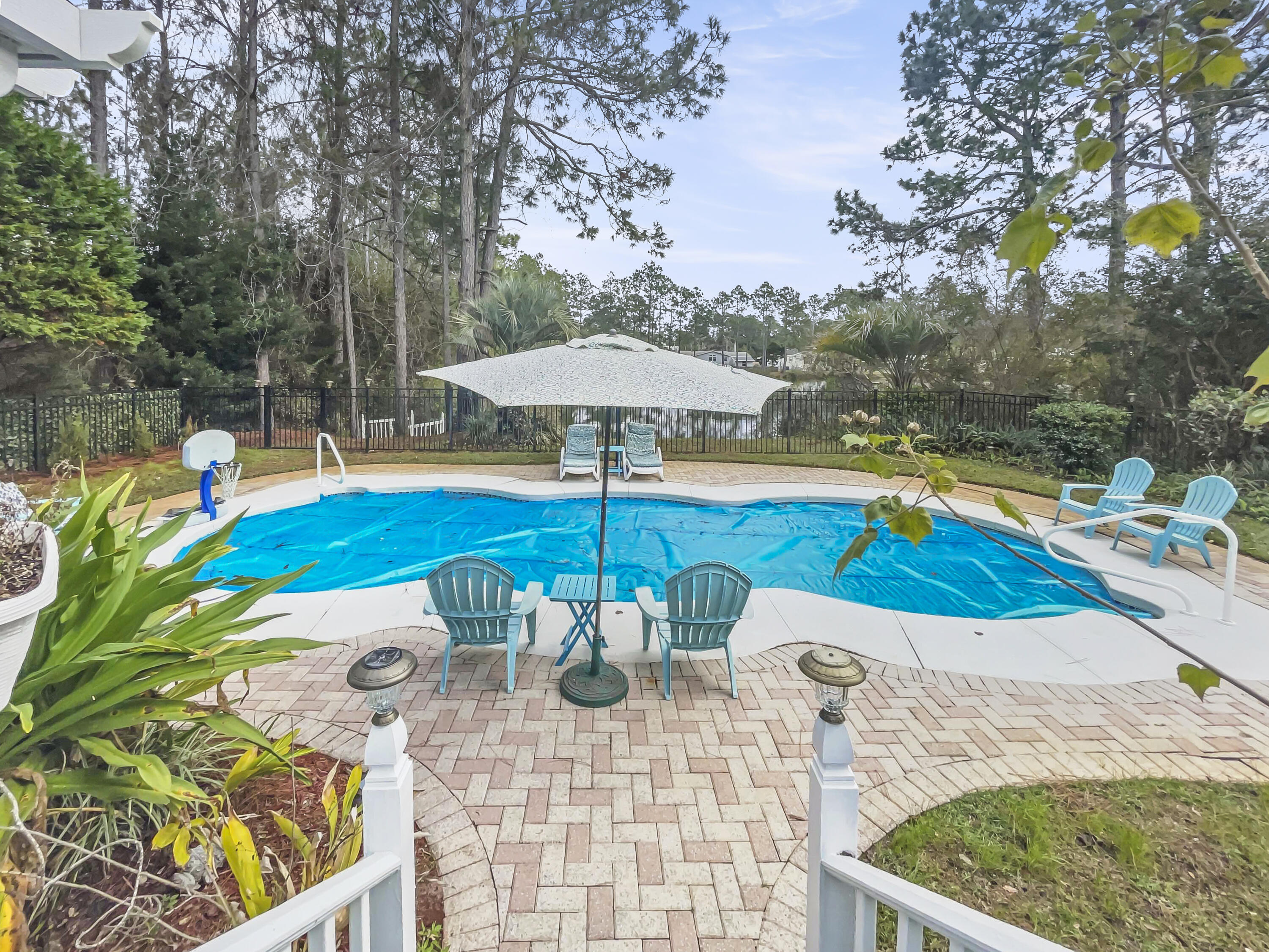 This home is a hidden gem located just off of 30A, South of Hwy. 98 within 2 miles down a bike path to a Ed Walline beach access! Make this your primary or secondary home. This home has a private heated pool, 2 car garage, 2 living areas, a separate Coy pond, within a year old main electrical panel, all plumbing, and a water heater. Relax on the covered back patio while the family is in the pool and grilling amongst the serene setting overlooking beautiful fresh water pond. So much to enjoy. This is a must see!