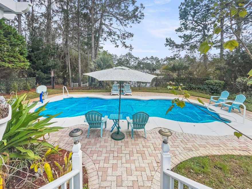 This home is a hidden gem located just off of 30A, South of Hwy. 98 within 2 miles down a bike path to a Ed Walline beach access!  Make this your primary or secondary home. This home has a private heated pool, 2 car garage,  2 living areas, a separate Coy pond, within a year old main electrical panel, all plumbing, and a water heater.  Relax on the covered back patio while the family is in the pool and grilling amongst the serene setting overlooking beautiful fresh water pond.  So much to enjoy.  This is a must see!