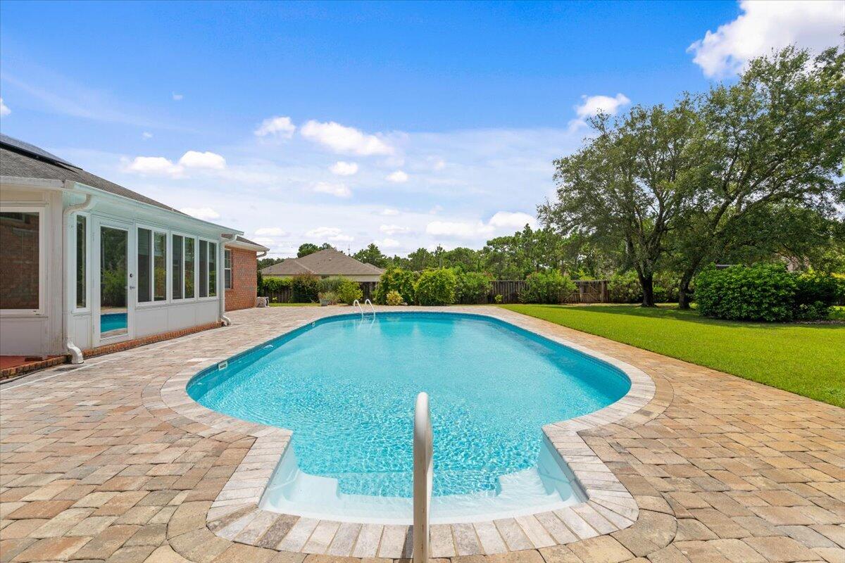 This move-in ready home offers 2,384 square feet of beautifully maintained living space on a sprawling half-acre corner lot in Holley By The Sea! Not only does this home have 4 bedrooms and 3 bathrooms it also has a fully enclosed heated/cooled Florida room that opens up from the main living area. From the Florida room you step outside and it opens up to the inground pool with a beautifully landscaped yard. This exceptional property sits on a prime corner lot with enhanced privacy and space, featuring seamless indoor/outdoor living that flows from the main living area through the year-round climate-controlled Florida room directly to the resort-style inground swimming pool surrounded by mature, beautiful landscaping. The home is completely move-in ready with fresh paint throughout and comes with incredible value-added features including a fully paid solar panel system. This property represents an exceptional value with immediate cost savings from the fully paid solar panel system that means significantly reduced electricity bills from day one. Water heater is from 2024 as well as a newer HVAC system! Don't miss this opportunity to own a piece of paradise! Schedule a showing today!