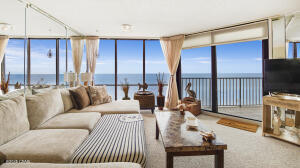 NEW AC UNIT/ NEW WATER HEATER AS OF JUNE 3, 2025! This expansive, Gulf-front two-bedroom, two-bathroom condominium is nestled within the highly sought-after mid-rise Windward building, situated on the serene west side of Edgewater Beach and Golf Resort. From the moment you step into this third-floor residence, you are greeted by breathtaking, panoramic views of the sugar-white sands and mesmerizing, emerald-green waters of the Gulf of Mexico. Floor-to-ceiling windows spanning the living room, dining area, and kitchen ensure an uninterrupted coastal vista, flooding the space with natural light and an unparalleled sense of openness. A distinctive highlight of this unit is the striking reflection of the nearby pier, elegantly captured in the living room mirror--a truly unique touch.