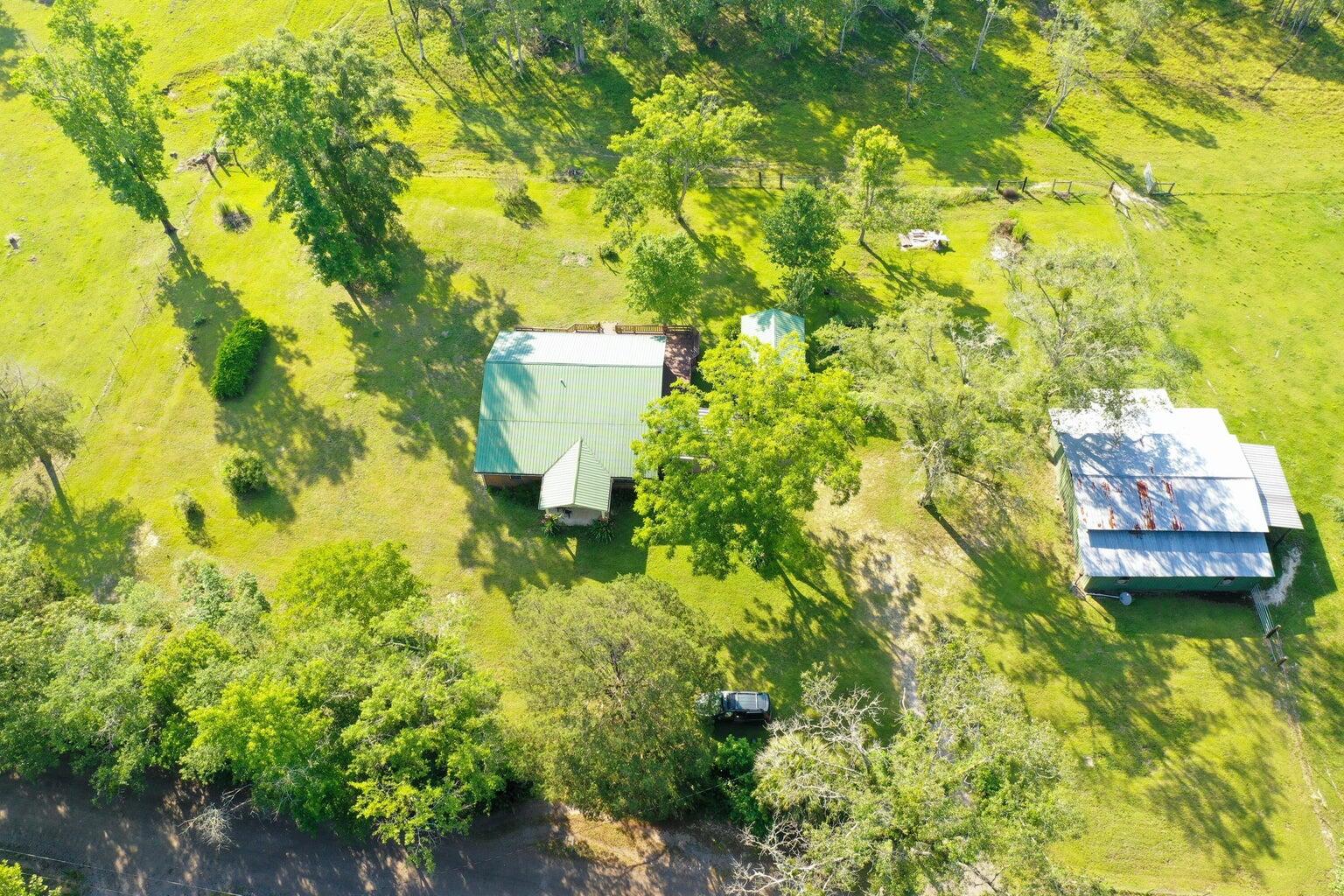 LOOKING FOR Tranquility and Freedom from disturbance? 10.12 acres, a place to raise large garden, raise animals no restrictions. The home is in excellent condition, metal roof in 2022, Remodeled kitchen  2006/2022 with 2022 granite countertop and  outdoor kitchen for the summer,  added patio 2022 with screened enclosure, 40x46 barn with concrete floor, outside deck for viewing and listening BIRD singing, cows grazing, ENJOY Matures Trees such as Pecan, Hickory walnut, Muscadines grapes, Persimmon, and other plants seller might leave behind. New road in hwy 331 it takes 40-43 minutes to SEASIDE. 54 Minutes to Silver Sands Outlet, 14 minutes to Medical Center, 20 minutes to Defuniak Springs, 55 Minutes to Eglin AFB and Destin