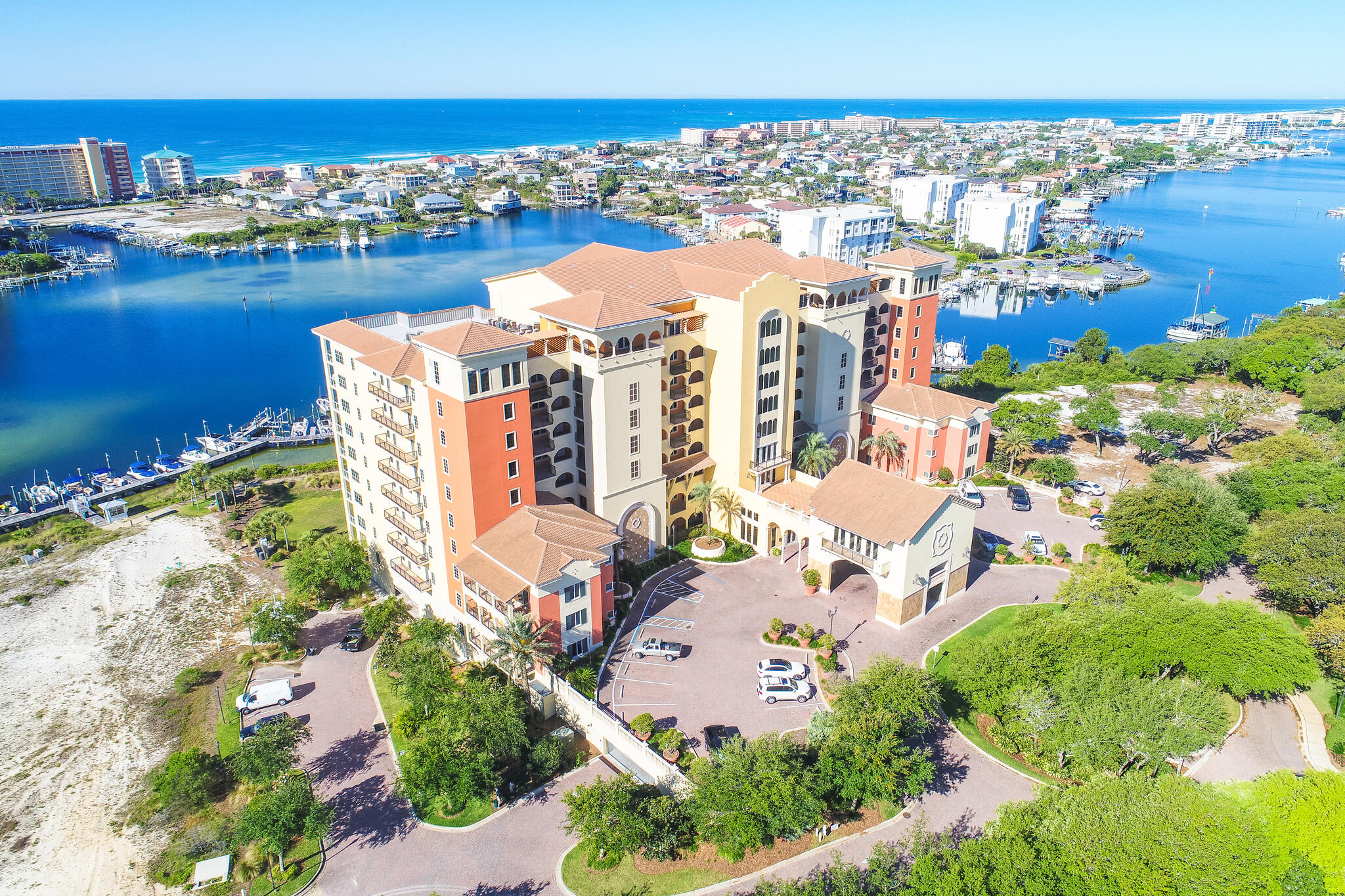 Waterfront fully furnished condo with exceptional views of Destin Harbor, East Pass, and the Gulf. Private veranda, three bedrooms, three baths, media room, and plenty of space and natural light. Conveying with this condo is a covered parking spot, storage. The kitchen offers a breakfast bar, built in stove, built in microwave, smooth cooktop and dishwasher. Washer and dryer convey and are conveniently located just off the kitchen. New luxury vinyl flooring, and fresh paint. The main suite is spacious and has access to the veranda, and an en suite bath that features dual sinks, soaker tub and beautiful glass shower. Marbella offers incredible amenities; heated pool, spa, Owner's lounge, and a workout center with new equipment and a professionally managed Marina