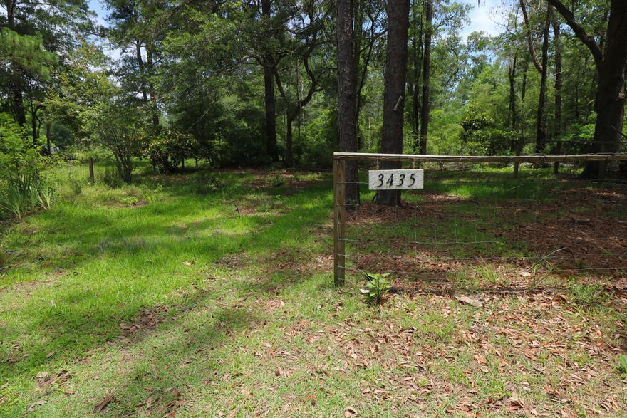 Budding Beauty! Beautiful flowering landscaping and oak trees on this 1 acre home-site. There is an additional 2.63 acres of land for sale on one side and a single family home on 1 acre for sale on the other side if you need additional space. Currently, a single-wide mobile home on property that is rented but value is for land only. Already hooked up to city water and sewer. 34 miles to Northwest Florida Beaches International Airport and ''The World's Most Beautiful Beaches'' of Panama City Beach.