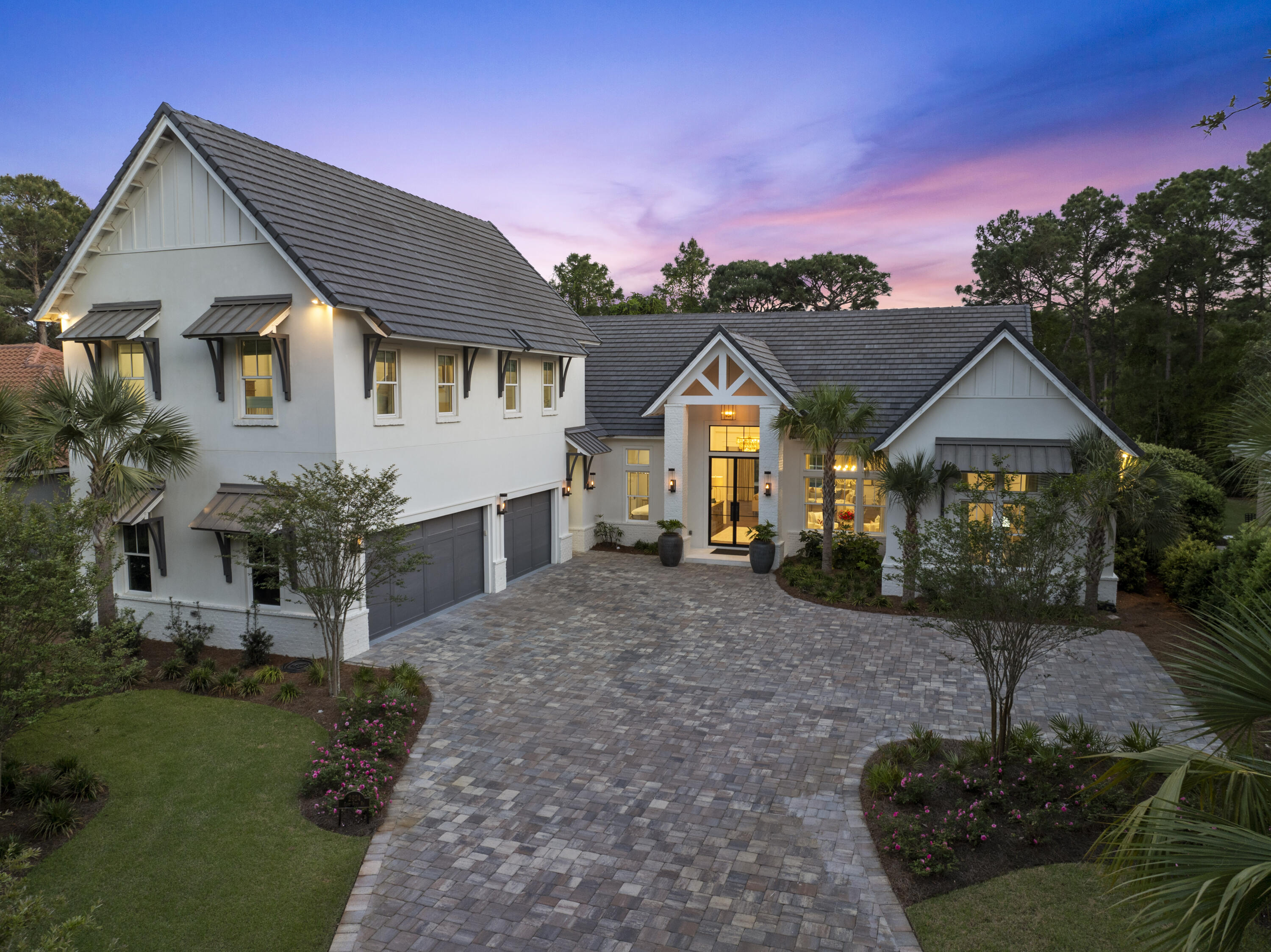 Experience luxury living in this custom-built 4-bedroom, 5-bath home nestled on the prestigious Burnt Pine Golf Course within Sandestin Golf and Beach Resort. From the moment you arrive, the striking modern design sets the tone with elegant gas lanterns, grand 10' entry glass doors, and lovely paver driveway that welcomes you to a one-of-a-kind sanctuary. Inside you are greeted by soaring 12'-15' ceilings, with a dramatic 20' cathedral ceiling in the main living area, centered around a stunning shiplap fireplace wall with mantel. Designed with entertaining in mind, the open floor plan seamlessly connects the expansive great room to a gourmet chef's kitchen complete with a 10' island, top-of-the-line Miele and Thermador appliances, including a 48'' dual-fuel range, two ovens, icemaker, double dishwasher drawers, a 6' built-in refrigerator/freezer, and a butler's pantry. A stylish wet bar with wine fridge, cooling drawer, and an additional ice maker adds to the home's entertaining appeal. Beautiful wood flooring flows throughout the residence, leading you to a luxurious primary suite featuring a cathedral ceiling, private sitting area and 10' Eurowall doors that open to the pool and courtyard. The spa-like bath is equipped with a large soaking tub, oversized shower with electronic controls, smart toilet, and an expansive custom closet with its own washer and dryer. A dedicated HVAC system, dual tankless water heaters, and automated Lutron shades and Forest Drapery ensure ultimate comfort for the primary retreat.
Two spacious bedrooms with en suite baths and a grand foyer round out the first floor. Multiple access points open to the private courtyard, where a resort-style pool, hot tub, and waterfall feature are the centerpiece of the home's outdoor living area overlooking hole 7 of Burnt Pine Golf Course. The screened lanai features an impressive 23' cathedral ceiling with white painted brick, an electric fireplace, electronic screens for easy access to the pool and a full outdoor kitchen outfitted with a gas grill, side burners, warming drawer, island with sink, icemaker, fridge/freezer drawers, and a dishwasher drawer.
The second-floor guest suite is accessible by stairs or elevator and features a private living room with cathedral ceilings, a full kitchen with GE Caf?? appliances, a large bedroom with en suite bath, walk-in closet, and its own laundry area, perfect for guests or multi-generational living.
Additional standout features of this exceptional home include an oversized garage with 3 EV charging stations, 4 tankless water heaters, open cell foam insulation for energy efficiency, a large walk-in pantry and dedicated laundry room on the main floor, outdoor motorized retractable shades on the lanai, and the home is equipped with state of the art systems from Sonos to top of the line security and Wi-Fi systems.
Boasting just under 5,600 sq ft with 4,500 sq ft of ground-floor living and an elevator making it easy to access the second floor, this stunning custom-built home offers a phenomenal opportunity for modern luxury living in a premier golf course and beach resort setting. This mesmerizing home is in a prime location within the renowned Burnt Pine community, which is in close vicinity to the Choctawhatchee Bay, along with easy access to Baytowne Marina, and the designated Sandestin beach along the emerald waters of the Gulf. Burnt Pine is the exclusive, gated community of Sandestin Golf and Beach Resort and offers many first-class amenities, fine dining and fun entertainment options, as well as an award-winning golf course!