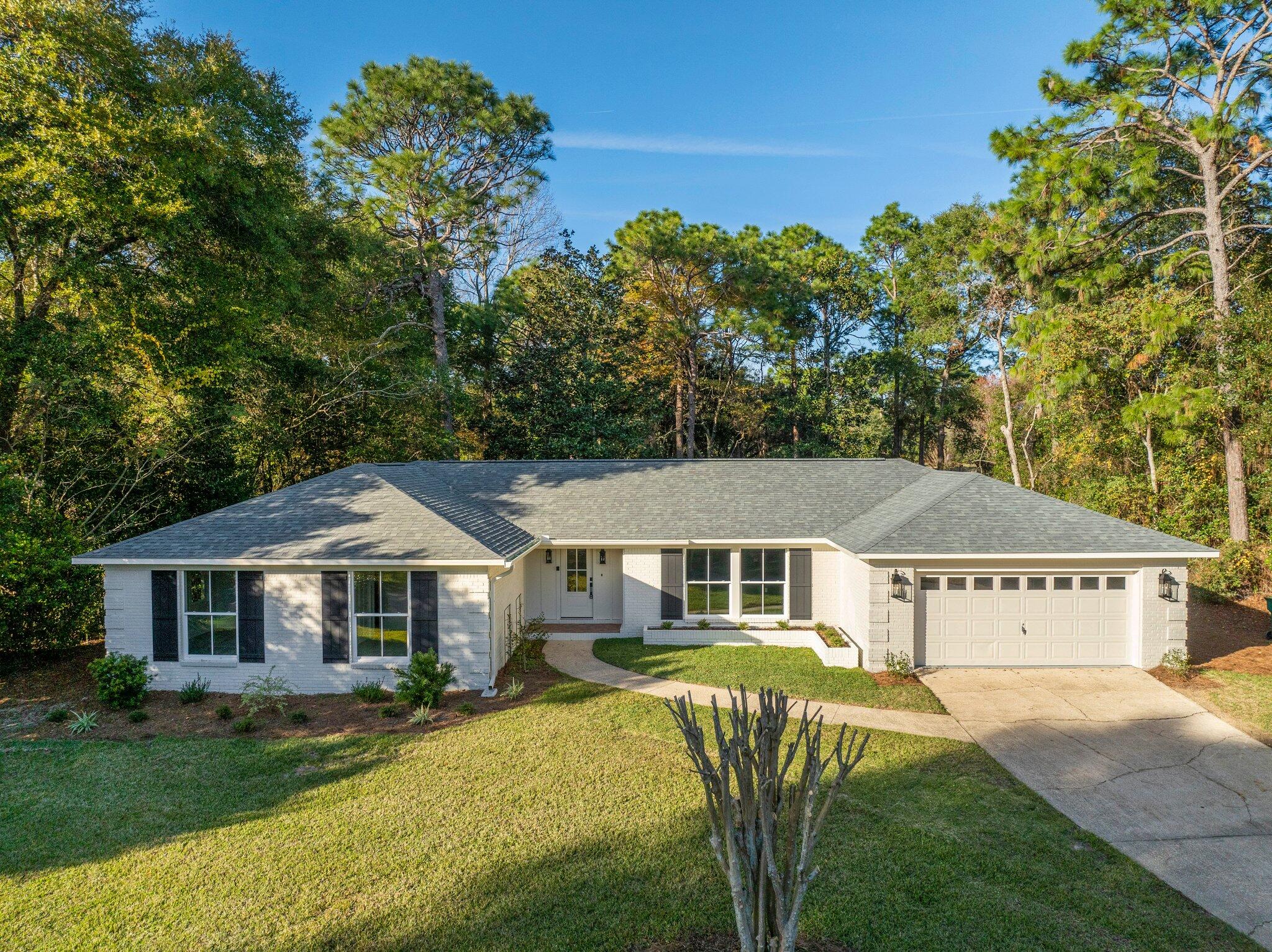 This beautifully renovated property is nestled in highly desired Rocky Bayou Country Club Estates. The single story home offers professional design with luxury amenities and stylish selections.  As you enter through the spacious foyer, the gorgeous 6.5'' wide-planked French oak hardwood floors immediately catch your eye.  Your attention is then drawn towards the custom private office/study with generous moulding details, a hidden wall closet, ample natural light and a rich slate color to set a sophisticated tone.  Leading out from the study connects you to the kitchen.