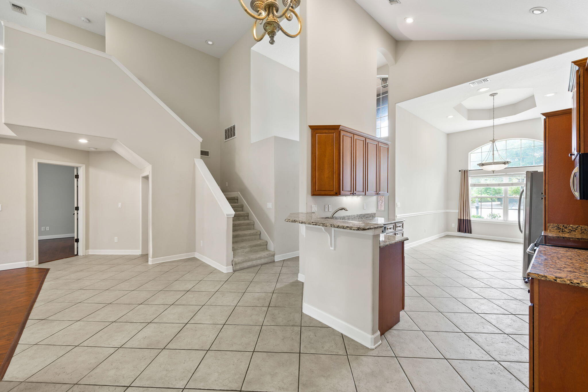 If you are looking for an affordable home close to base you hit the jackpot! Soaring ceilings of 12' to 16' in the main living area in addition to a direct view of the Intercostal from the loft. Transom windows on south side allow for plenty of light. Large formal dining room in addition to the breakfast bar area off the kitchen. Gorgeous kitchen with granite counters and nice wood cabinetry. Downstairs master suite has an absolutely stunning master bath area. Master bath has a large separate shower and an oversized whirlpool tub. Beautiful oversized ceramic tile on walls. Of course, there is a double sink vanity in the bathroom. Loft is great for office, media room! The indoor laundry room is conveniently located as you come in from the garage with an additional half bath for guests o the foyer as well; Fully fenced yard is convenient for children and pets! Located on a cul-de-sac, plenty of privacy and great area for kids to play! Check out today!