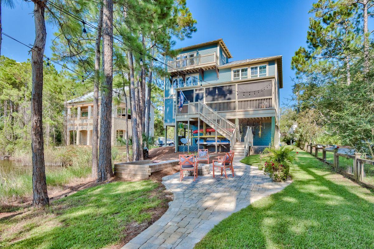Located along Eastern Lake, one of Florida's rare coastal dune lakes, and just minutes from the Gulf of Mexico, this inviting coastal home offers 100+ feet of water frontage along a quiet canal. Open living areas make this home ideal for seamlessly entertaining, and a custom kitchen offers granite countertops and stainless steel appliances. 3,525 sq ft of living space includes two spacious owners' suites with custom built closets and two bedrooms. Four total bedrooms offer plentiful space, while the top level recreation room could easily convert into an expansive bunk room, ideal for those looking for an investment property or multi-generational retreat. Thoughtfully-designed both indoors and out, this home features several exterior amenities, including a