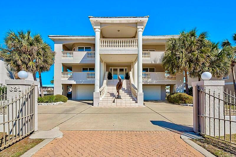 $200,000 PRICE REDUCTION! Expansive Gulf views and two covered boat slips-your own piece of paradise! Located on exclusive Holiday Isle, this immaculate 4 bedroom/4.5 bath home is a boater's dream and is just steps away from the white sandy beaches of the Gulf of Mexico. This one-of-a-kind property sits on 80' of canal water and features TWO covered boat slips-one of which can accommodate a 50 ft. yacht! Made for entertaining, this home boasts plenty of outdoor living space with wraparound porches on the 2nd and 3rd floors and a large, partially covered deck with a granite bar and canal views. A rooftop deck provides a 360-degree view of the Gulf and canal. These breathtaking views can also be enjoyed from the large balcony on the front of the home.
