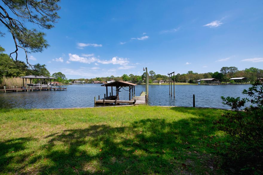 WAIT UNTIL YOU SEE THE VIEW FROM THIS HOME!! The lot is almost 1/2 acre and has over 100ft on the water. The front and back yards are abundant with foliage: age-old trees, azaleas and camellia are prolific.This custom built, one-owner property, was constructed in 1982 with 2x6 walls! Upon entering the foyer it's easy to envision the remodel that will revitalize this three-level home to take advantage of the stunning views and make it your own.