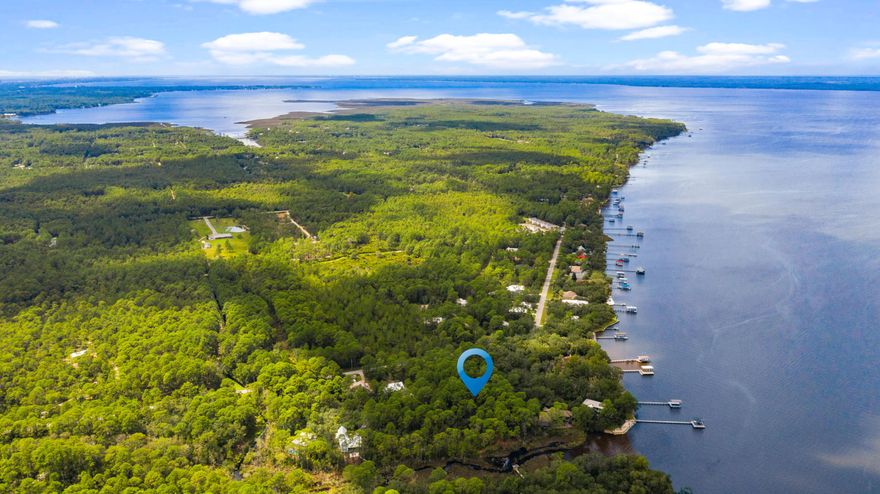 Rare to find a level dry lot just under 3/4 acre with bay access for under $350K! Enjoy stunning sunrises off the Choctawhatchee Bay. The location, at  the entrance of the bayou, provides beautiful views while still offering protection from strong storms. On this lot, your future home can be built on a slab rather than building on pilings making it an excellent option for those who desire a first floor master, ranch style home, or who have aging relatives. Want to fish, kayak, paddle board, or have a boat? This parcel allows for a dock to be build at various lengths depending upon how you chose to use. The owner is a designer who has starred on multiple episodes of the hit TV show on A&E, Sell This House! Owner has stunning plans for a dream home that she designed that can be built on this lot. Prospective plans can also include a carriage house and pool.

About the Neighborhood:
Eden Estates offers the privacy and natural beauty that makes people want to call Santa Rosa Beach home. North Santa Rosa Beach is growing steadily and there are plans for expanding the school system, community attractions, nearby beaches, and even plans to build an amphitheatre for music and other venues.