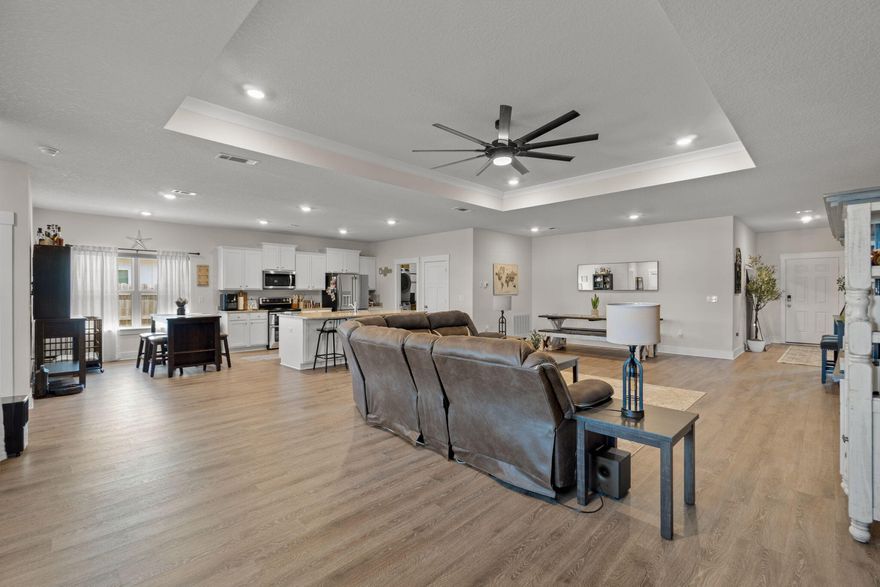 **3.375% ASSUMABLE VA LOAN** Welcome! This 4-year-old home offers a functional open-concept layout with the living room as the central focal point, making it ideal for hosting and everyday living. The main living area flows seamlessly into the kitchen and dining space, creating a comfortable and practical setup for gatherings. The backyard has been upgraded with an additional concrete patio, new palm trees, and a fully fenced yard, providing privacy and usable outdoor space. Custom LED lighting has been installed along the front of the home and around the back patio, with color options that can be adjusted for different seasons or holidays. This home is approximately 20 minutes from Pensacola Beach, 15 minutes from Navarre Beach, and 30 minutes from Hurlburt Field.