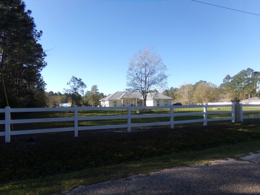 Country living just minutes from down town Milton~ Well constructed 3 bedroom 2 bath, split floor plan on 8.3 acres~ Living area boast of tile flooring, bedrooms carpeted~ Kitchen opens to dining room and living room~ Nice back porch to enjoy the beautiful serene surroundings~ Large 40x50 metal building and the property is fenced and crossed fenced~