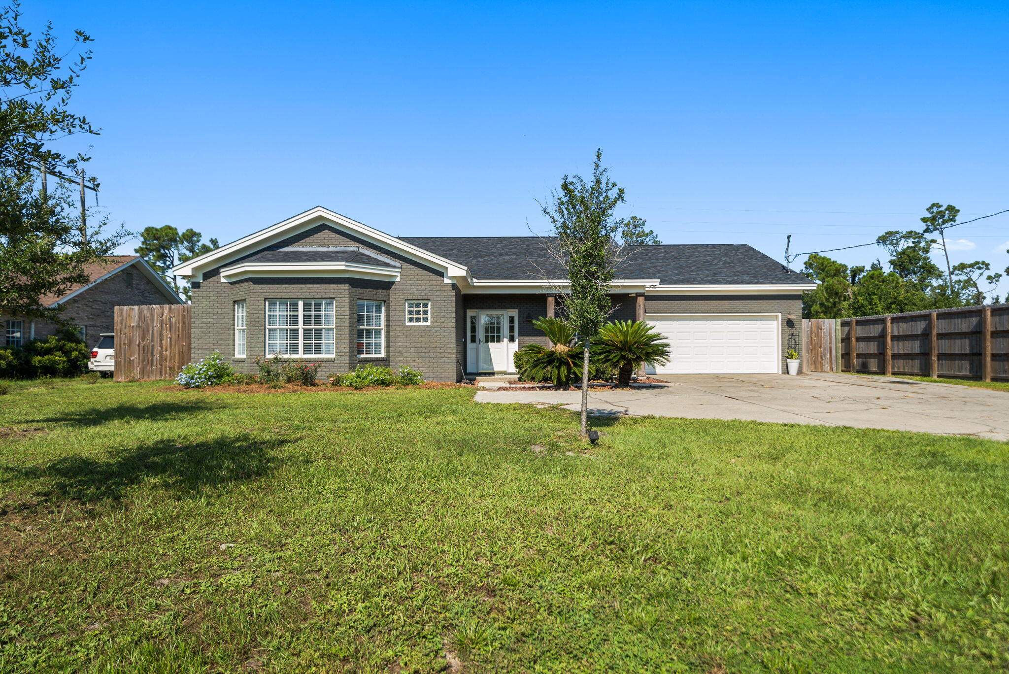 OPEN HOUSE Friday, 8/22 11am -2pm + Saturday, 8/23 1-4pm! Set on a expansive .58-acre corner lot in the heart of Panama City, this impeccably maintained home blends space, comfort, and convenience...all with no HOA. If you're looking for a home that has room to grow as well as space for RV, boat, trailers, tractors and more, this is it! Inside, soaring ceilings and natural light create an inviting feel. The home offers 3 bedrooms, 2 bathrooms, a split floor plan, a sitting room and a bonus room so grand you didn't even know you needed! The bonus room is a gem because it offers access to the exterior which is great for multi-generational living, play room accessible to the outside play area or a man room to hang.
Enjoy an effortless indoor/outdoor lifestyle with an oversized covered porch across the back of the home as well as a lush landscaped yard for the kids and animals to play! This home offers a 36'x48' pole barn, complete with a slab and perfect for storing your boat, RV or trailers. In addition, there is a detached garage next to the pole barn that is 32'x24' and perfect for a tractor, tools, workshop or storage for additional vehicles. There is also an incredibly built chicken coop in the backyard and you'll love having chickens at home and fresh eggs daily! With expansive room for a private pool, you're going to love this yard!
This kind of living isn't found often in the center of town and is rare! An opportunity that doesn't exist often.
This home has been impeccably maintained and boasts a 2024 roof, new insulation and HVAC that is only 2 years old. The Seller even thoughtfully designed an 8-foot privacy fence around the property for the ultimate backyard private experience! Complete with an attached 2-car garage, you'll love single level living with high ceilings throughout. The kitchen offers a breakfast area as well as a spacious pantry and laundry room combination that overlooks the front yard. The dining room offers high ceilings and a sitting room adjacent that overlooks the back yard. The bonus room is just off the dining room and offers double pocket doors to be able to offer privacy when desired. The living room features a fireplace and sitting area with ample space for larger furniture with light flooding in from the front and back of the home.
Off the living room, you'll have access to the primary suite with large windows overlooking the back yard, a shower/tub combo and two closets. Off the foyer, you'll find an updated full bath accessible by the hallway for guests and two large bedrooms with great natural light. Located in the center of town, this home offers quick access to SweetBay's new town center, Publix, dining, shopping, and downtown Panama City. Being a two minute drive from 23rd Street is incredible for those who work at HCA Healthcare, professional offices or for those who desire to be within a few minutes to WalMart, additional dining options and shopping.
A rare opportunity to own a spacious home with privacy, practicality, and luxury...schedule your showing today! Seller has current survey and appraisal on property.
