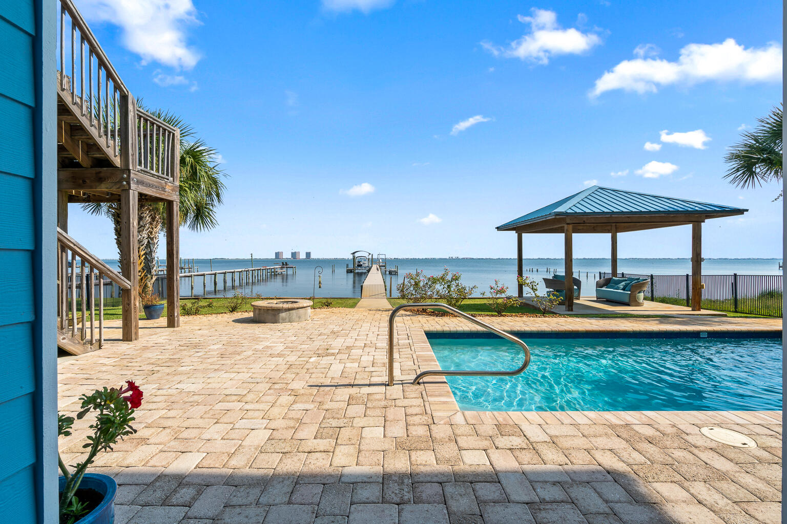 OPEN HOUSE June 21st 10am-12pm.Waterfront luxury in Gulf Breeze-only a short golf cart ride away from Tiger Point Golf Course. 2961 Bay St. offers 5-bedrooms and 5 bathrooms, a dock, pool & elevator. Enjoy breathtaking views of the Intracoastal Waterway, featuring a 250-ft pier with boat slip, lift, and two jet ski lifts, vinyl seawall, and new Trex decking. Enjoy resort-style outdoor living with a private pool and rock waterfall, gazebo, and an expansive balcony with built-in outdoor kitchen, gas grill, sink, and custom cabinetry.The main living area boasts a chef's kitchen with maple-glazed cabinetry, blue granite countertops, center island, flat cooktop, and built-in oven. The open floor plan flows into a spacious living room with a gas fireplace, surround sound...See more... and stunning water views. Ten-foot ceilings, crown molding, eight-inch baseboards & eight-foot solid-core doors.
The primary suite offers water views, reclaimed wide-plank pine floors, trey ceiling, and a spa-inspired bath with walk-in travertine shower, whirlpool tub, Kohler fixtures, and his-and-hers walk-in closets. You will also find an additional 2 bedrooms, full bathroom with dual vanities plus a half bath for visitors.
The lower level functions as a complete in-law suite or income producing BNB with two bedrooms, two bathrooms, office, kitchenette, living area, and custom built-ins. Access both levels via a custom iron staircase or a cherry wood-paneled elevator.
Additional features include:
* Wet bar and entertainment center downstairs
* Cypress ceilings and IPE decking on the porch
* Surround sound inside and on decks
* Hurricane shutters for all windows and doors
* Mahogany front door
* Ample storage throughout
* 2 Huge garages!!
Located just two blocks from a boat launch and minutes from top-rated schools, shopping, and Pensacola Beach. Enjoy southern exposure, cooling Gulf breezes, and unforgettable sunrises and sunsets from your own backyard. This is coastal living at its finest!