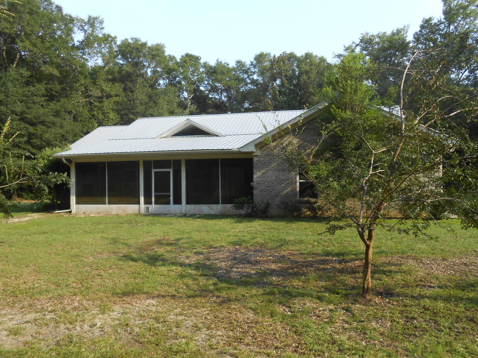 This all brick 3 bedroom 2 bath HomePath property is located on almost 5.5 acres. Home offers the split floor plan, metal roof, tile, granite countertops new carpet in two bedrooms, interior freshly painted. Oh yea, and a large walk in closet that all us women dream about. Screened in front and back porch covers the length of the home, and there is a door from the master bedroom that leads out onto the back porch. Call today for your private showing.
