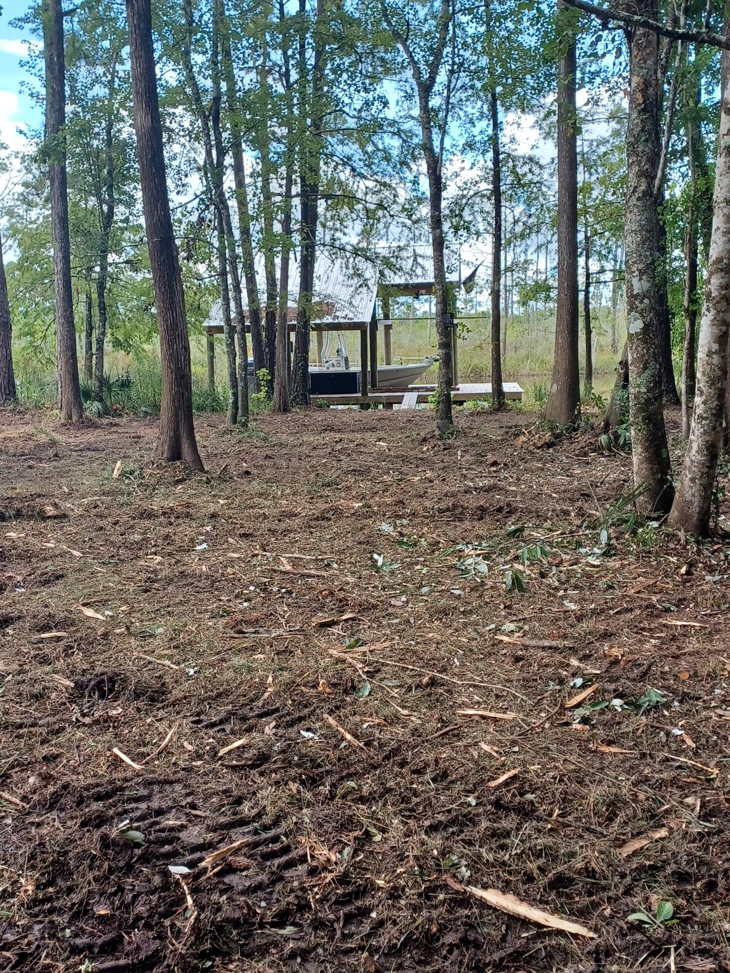 Located on deep water, this tranquil 77'x156' lot is private and ready for you to build your new home. The lot is surrounded by mature trees, providing a sense of seclusion and tranquility.This waterfront bayou lot offers easy access to the water for boating, fishing, and other water activities. The covered boat dock is perfect for storing your boat and enjoying the beautiful surroundings. Don't miss this opportunity to build your dream home on this picturesque lot on a quite and peaceful street. Call now and make this your own piece of paradise. Wetland delineation has been completed.