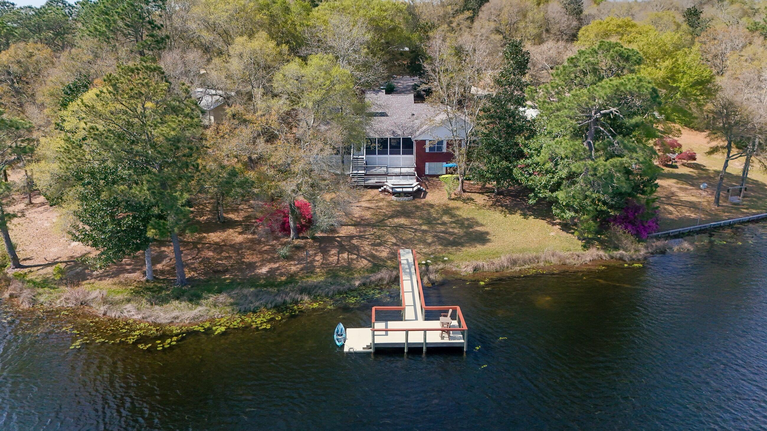 Beautiful 4 BR, 3.5 Bth, 2959 SF. home on Lake Holley in Defuniak Spgs. Home has view of lake from all BRs & living/kitchen areas. Kitchen features granite counter tops & stainless steel appliances. 1st floor master suite features a sitting area, jetted tub, large walk-in closet, opens to the screen porch. 2 addtl. BRs, 1.5 addtl baths & office on 1st floor. 4th BR, full bath & sitting area on 2nd floor. The spacious screen porch leads out to multi-level composite deck for grilling & outdoor entertaining. The dock, complete w/ kayak platform, was completely rebuilt in '21 (including new piers & composite decking). There is even an 18x31 bonus, finished walk-out basement accessed from the backside of home currently used as a rec room, which also boasts views of the lake. A true must see!!