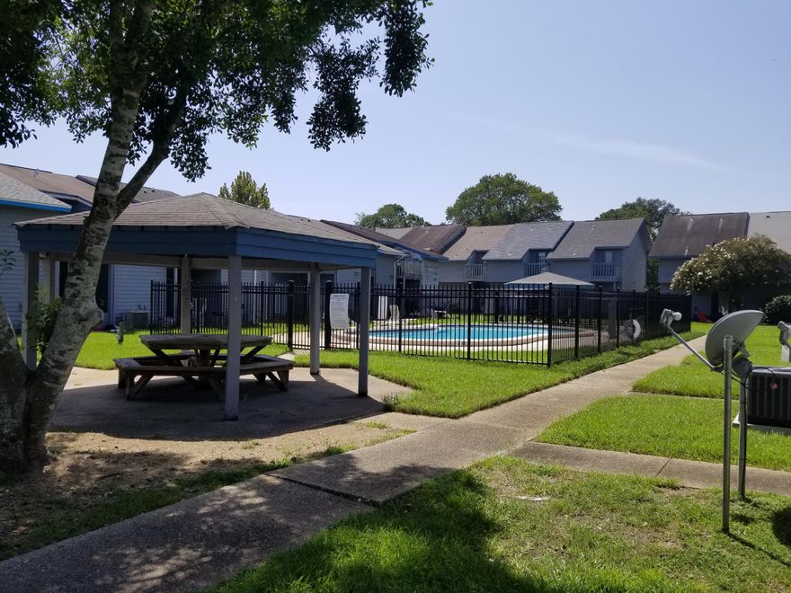 Back on the market again!  Buyer fell through! Beautiful townhome features new appliances, new balcony, security system, 2 bedrooms and 1 1/2 bath.  Walking into the peaceful living room with new carpet and stairs situated  to the right.  There is a half bath downstairs along with the kitchen, dinning area and huge laundry room.  Upstairs, you will find  two large bedrooms with NEW carpet and a full bath with new vanity.  The bedroom to the right features a walkin closet and tranquil balcony that looks out towards the relaxing pool and gazeboo.  There is even extra storage under the stairs and a screened/enclosed patio situated just outside the back door. This patio is perfect for those hot summer days.  Bring your family and friends to enjoy the nice sunny days by the relaxing pool.