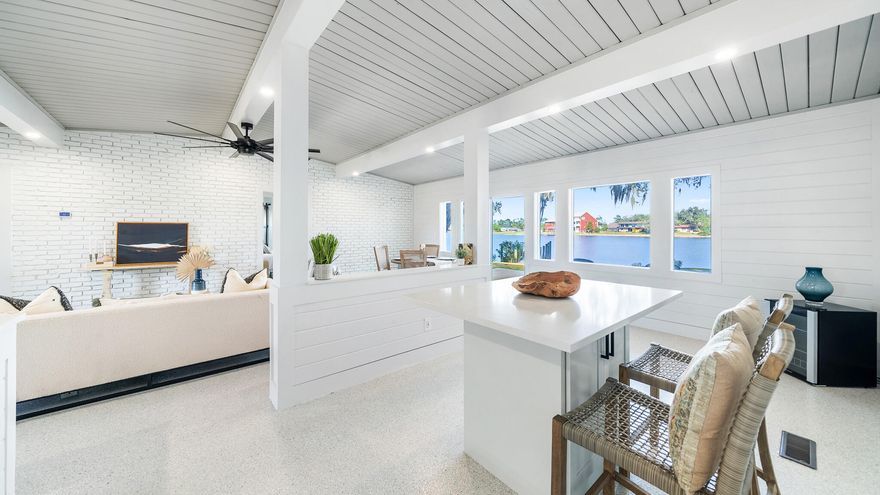 Discover your waterfront paradise on Shoreline Circle in Panama City, a stunning retreat offering a blend of elegance, comfort and breathtaking natural beauty. With 80 feet of waterfront on Pretty Bayou and a private dock, this property is perfect for a primary residence, a second home or a lucrative short-term rental. This beautifully renovated mid-century modern home boasts 1,936 square feet of living space, featuring three bedrooms and two bathrooms. The open floor plan creates a seamless flow between living spaces, enhanced by large windows that flood the home with natural light and provide panoramic water views.