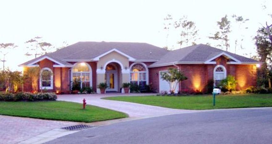 ABSOLUTELY BEAUTIFUL 2850 sq/ft all brick 4 bd / 3 Ba home w/ heated & cooled Florida room overlooking lake located in the Gated Community of Magnolia Plantation. The Kitchen has custom Cherry Cabinets, Granite throughout, Kitchen Aide Stainless Steel Appliances w/Gas Range. Wonderful Tuscan style with lots of arches, tile and wood flooring with detailed in-lays, plus custom window treatment which will convey. Every detail has been considered - large laundry room with built-in cabinets and deep basin sink, central vac, remotely controlled gas fireplace, built in Bose surround sound inside & out. Master Bathroom has double Vanities as well as Separate Shower and jacuzzi tub and Walk In closet. There are 18'' Ceramic Tiles throughout and a magnificent 1100 sq/ft outdoor kitchen.