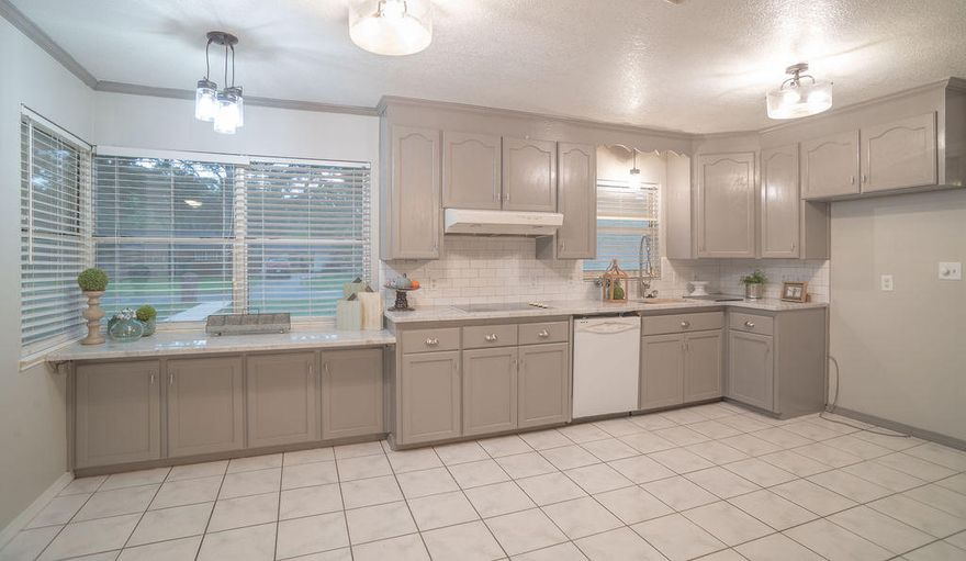 Spacious, ranch-style brick home on a large lot with mature trees, is located in quiet neighborhood near Nine Mile Rd, w/an easy drive to downtown Pensacola or Pace/Milton. This home features refinished hardwood floors, new carpet, lighting, ceiling fans, and fresh paint. The updated kitchen has granite countertops, subway tile backsplash, custom painted cabinets, a new faucet & sink, and adjacent large bonus room w/built-in desk. Cozy up to the stone-front fireplace and enjoy entertaining in the formal dining space. A large Florida room (348 sq ft) w/new carpet is accessed from the living room or the master. The private backyard is perfect for barbecues or a future pool. A circular driveway w/covered canopy provides ample parking and RV or boat storage.