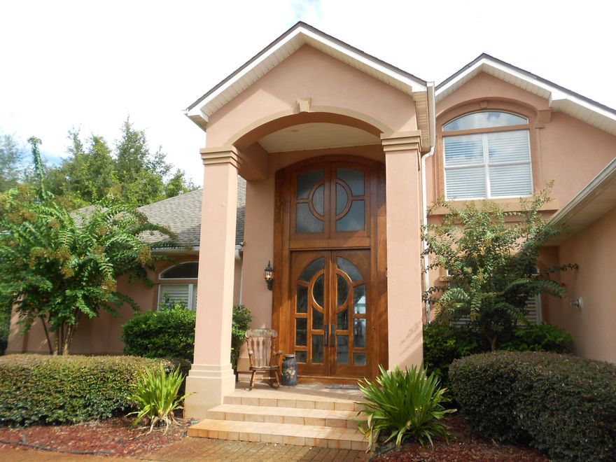 The Boathouse Retreat. Enjoy over an acre of luxury living on the bay in South Walton county between Destin and 30A. A secure gated entrance opens to a 200' palm lined circular driveway which approaches the house. There is plenty of parking for many guests in addition to the 4 car garage. The grand entrance of the house has elaborate 9' imported exotic sapele custom wood french doors topped with windows stretching to the 20' high foyer ceiling. An incredibly beautiful winding sapele staircase leads to some beds and baths while the master is downstairs. Incredible waterfront views & docking!