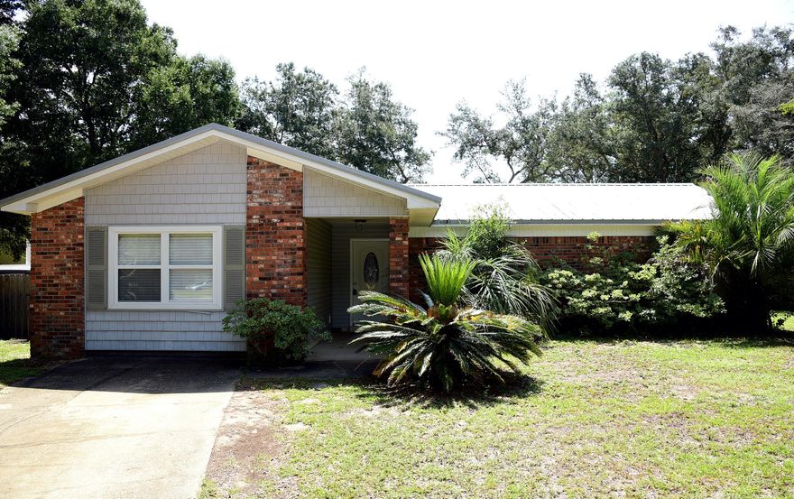 This centrally located Niceville home is conveniently located to schools, bases and beaches.  As you walk in the door you are greeted by a spacious living room, with a beautiful fireplace and laminate flooring. Each bedroom has plenty of closet space. You will enjoy the private office area off of the kitchen, also a great space for an entertainment room or play area. The large utility room has lots of space for storage options. Fenced-in backyard, as well more storage space with the detached storage unit.