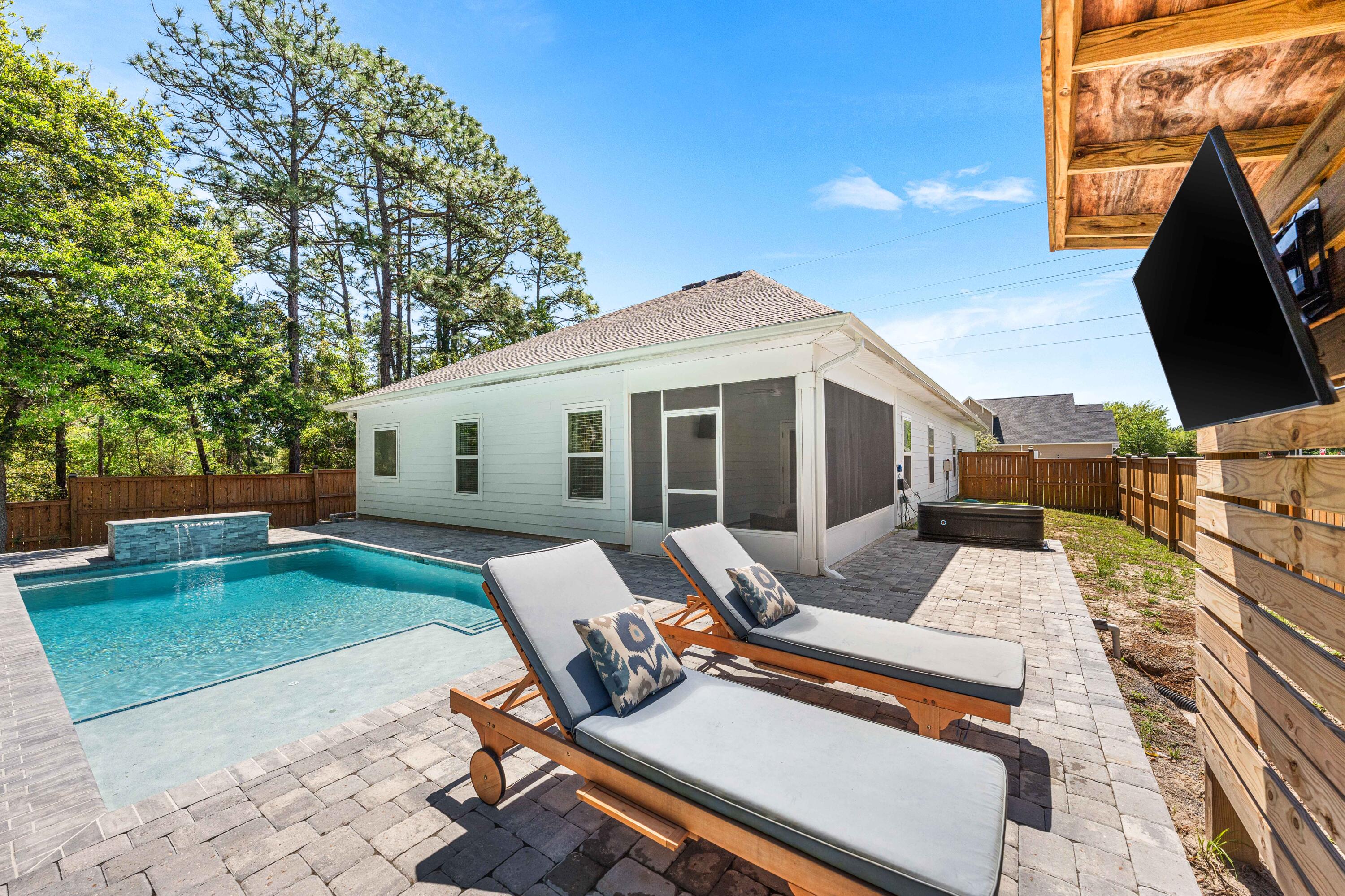 Welcome to your personal retreat at The Preserve at Paradise Cove in Point Washington! Located on a one-of-a-kind half acre lot and nestled amongst manicured lawns, lush trees, and a wooden preserve; this unique 5 bedroom, 3 bath, 2-car garage home offers unparalleled privacy and serenity. The potential for outdoor enjoyment is endless, boasting a sprawling fully fenced backyard, complete with a sparkling 12'x26' private pool surrounded with 900 sq ft of pavers, fire pit, and thriving garden area. Experience the ease of convenience with quick access to the Choctawhatchee Bay, South Walton's white sand beaches, the many towns along 30A, Eden Gardens, as well as numerous hiking and biking trails. Claim your private oasis amongst the natural beauty of Point Washington in Santa Rosa Beach FL! Additional property features include wood grain LPV flooring and quartz countertops throughout, custom painted cabinetry, designer lighting package, stainless-steel appliances, well/pump with a 6-zone irrigation system and drip set up in the front flower beds plus more! The Preserve at Paradise Cove is a charming community located in Santa Rosa Beach, FL and offers peace, quiet, and convenience being a short drive to 30A's white sand beaches, top-rated schools, Choctawhatchee Bay, numerous state park trails, Destin, Panama City Beach, and more. Claim your retreat at 11 Jrs Way today and enjoy the best of coastal living!